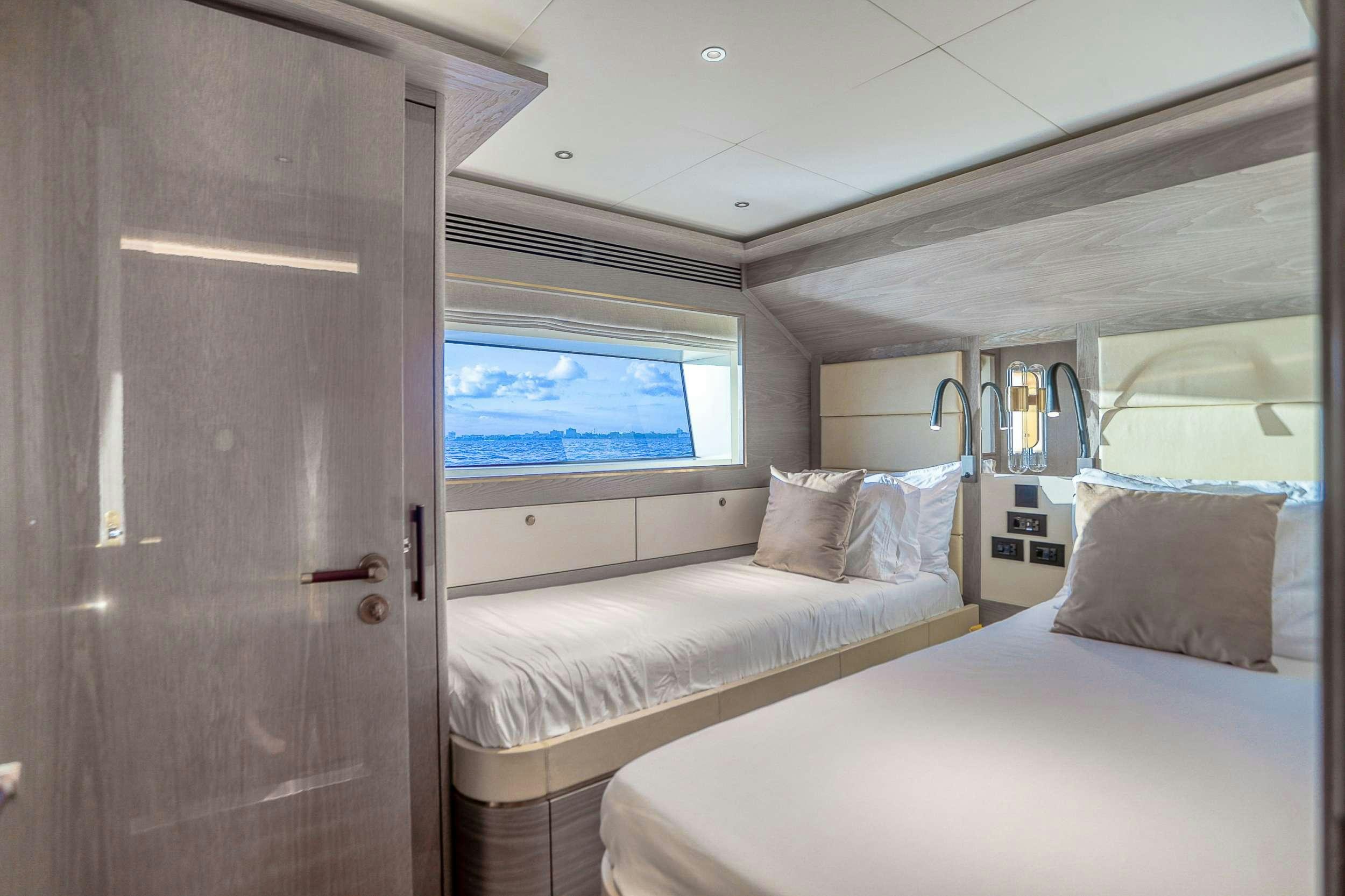 a room with two beds aboard SAINT Yacht for Charter