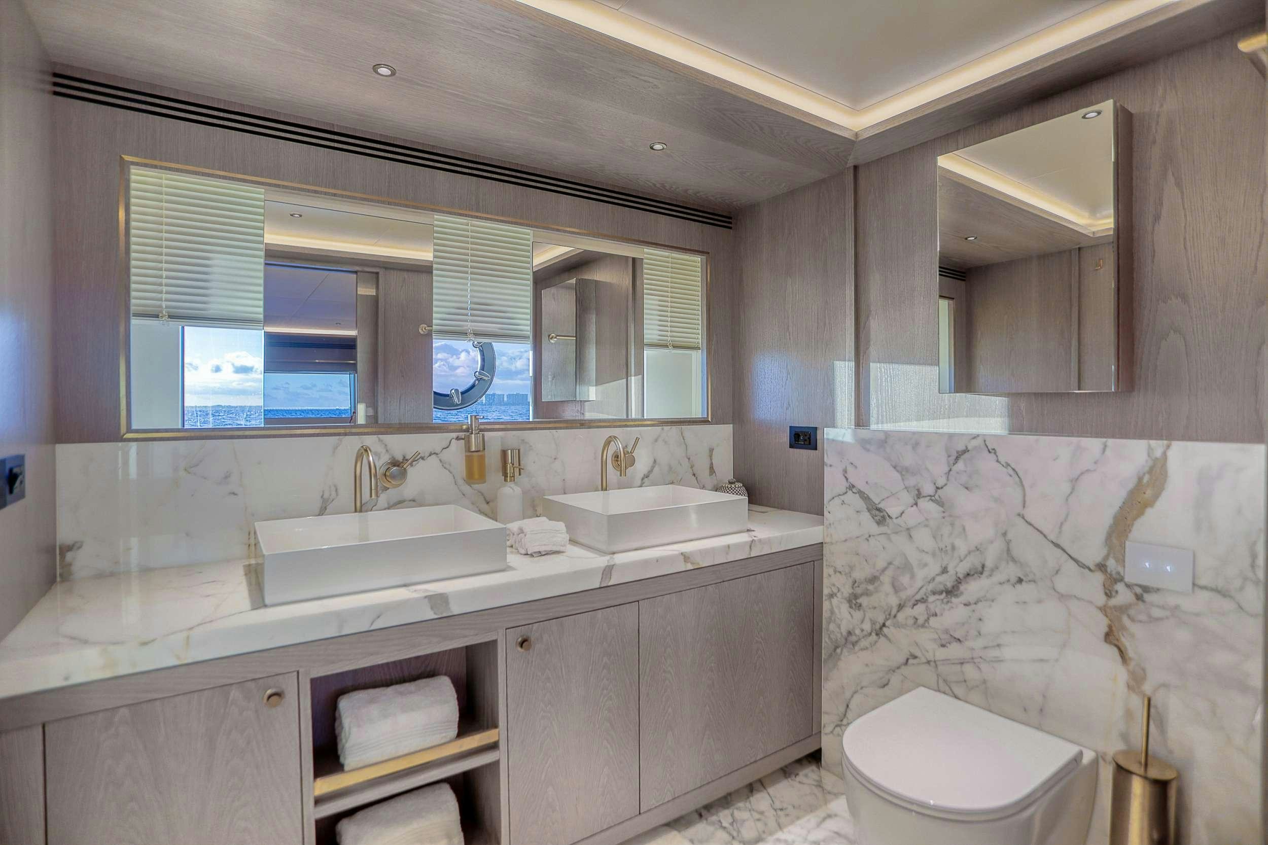 a bathroom with a sink and a toilet aboard SAINT Yacht for Charter