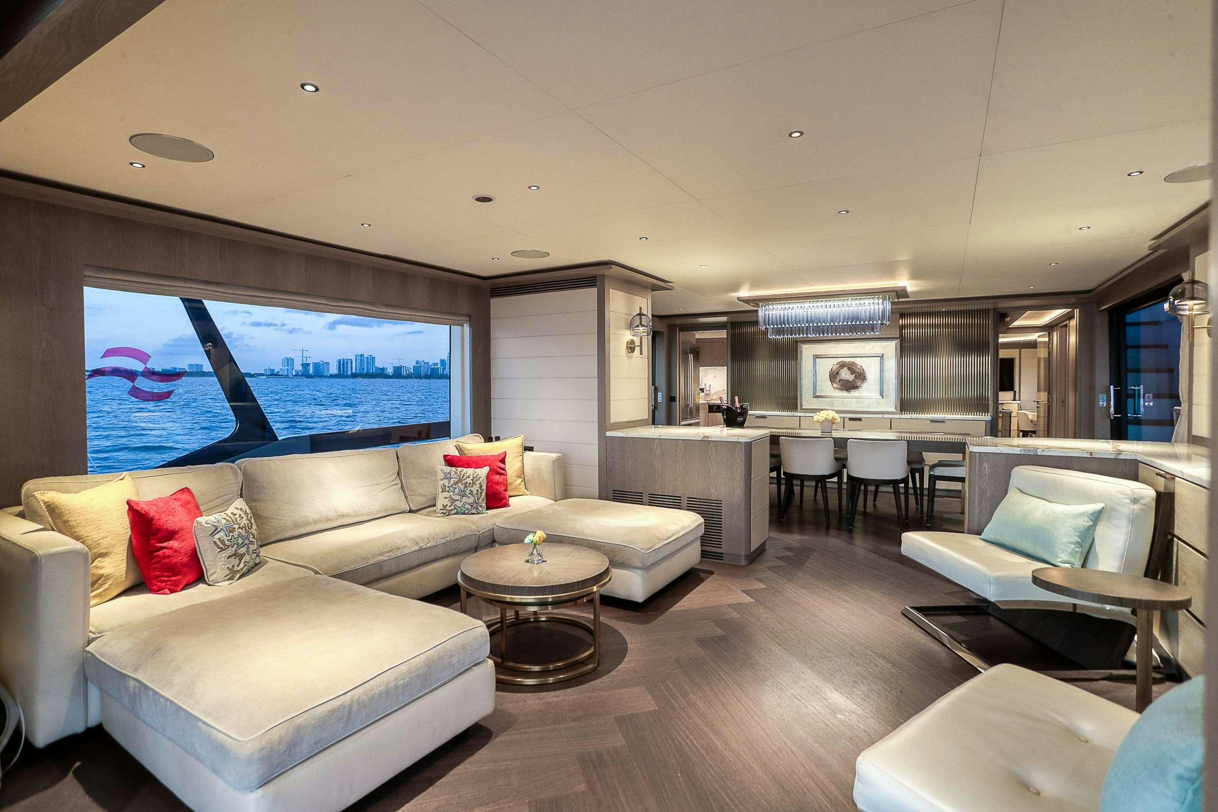a living room with a large screen aboard SAINT Yacht for Charter