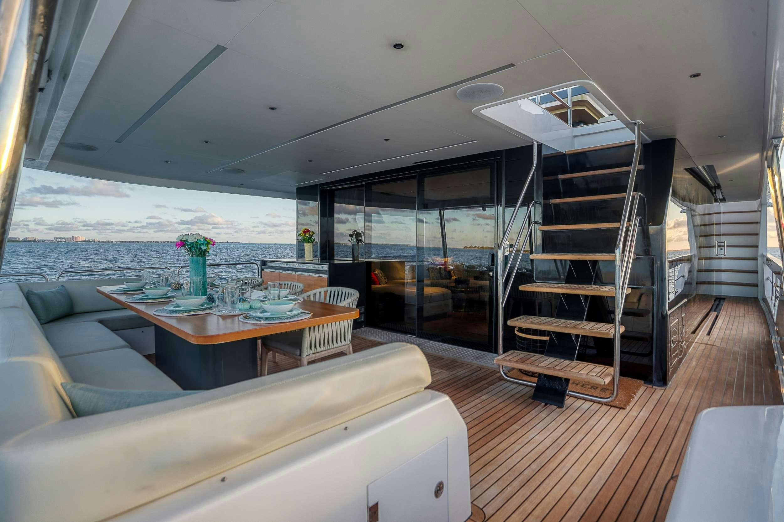 a living room with a large glass door and a balcony aboard SAINT Yacht for Charter