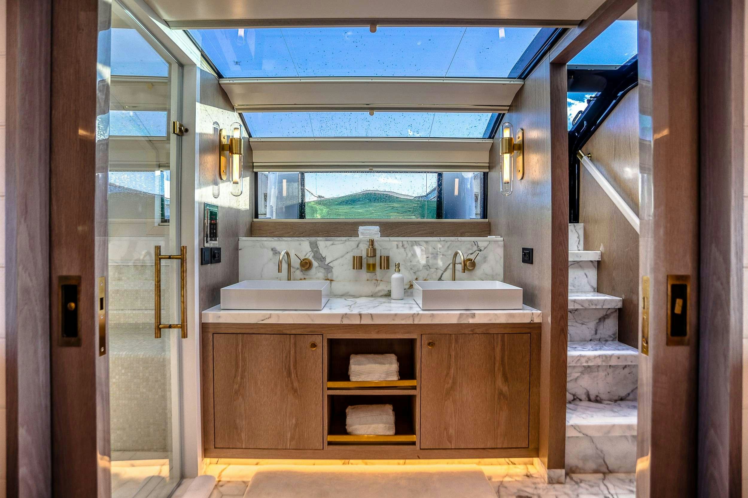 a bathroom with a sink and a mirror aboard SAINT Yacht for Charter