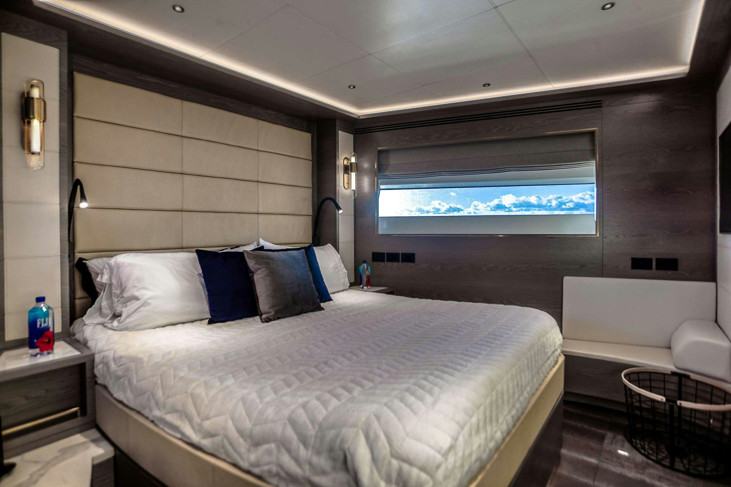 a room with a bed and a window aboard SAINT Yacht for Charter