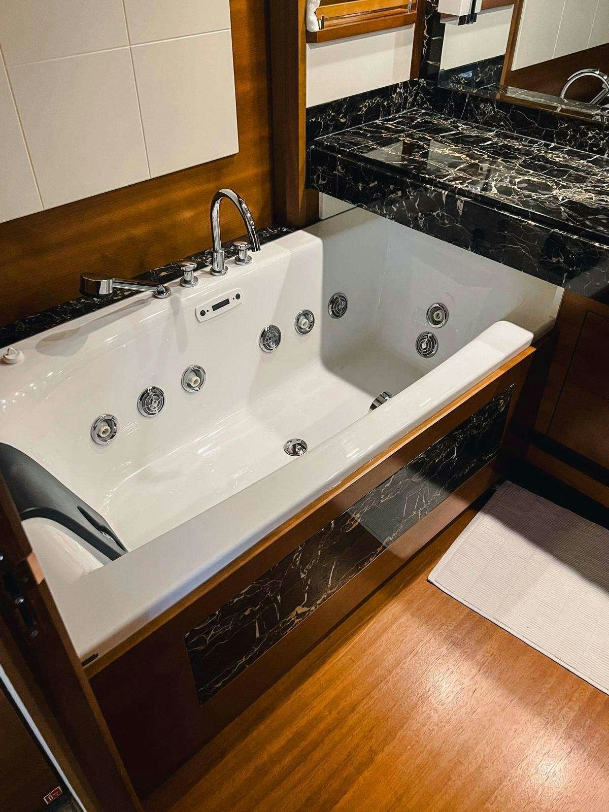 a bathtub with a sink aboard EL GABO Yacht for Charter