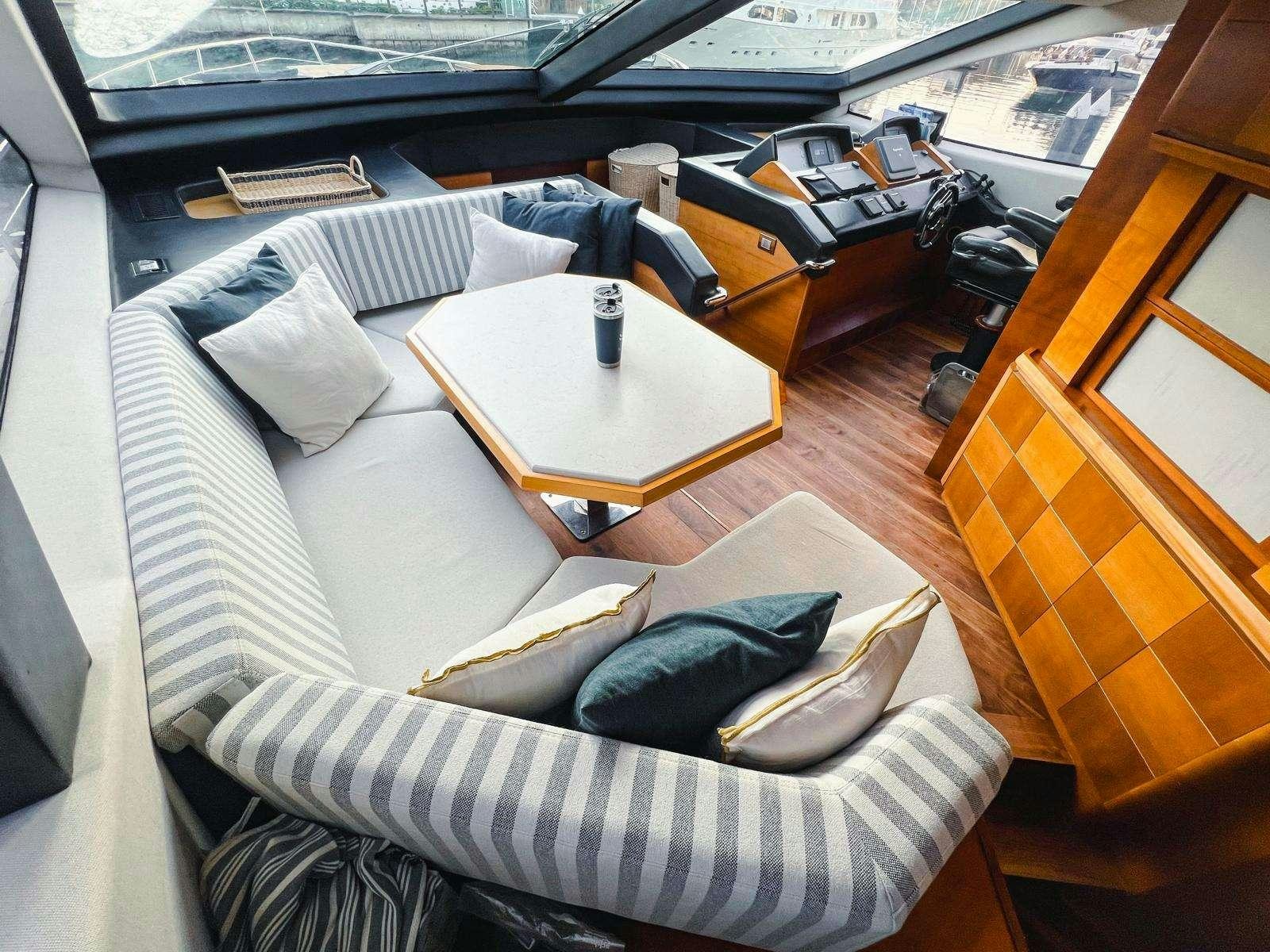 a couch and a table in a room aboard EL GABO Yacht for Charter