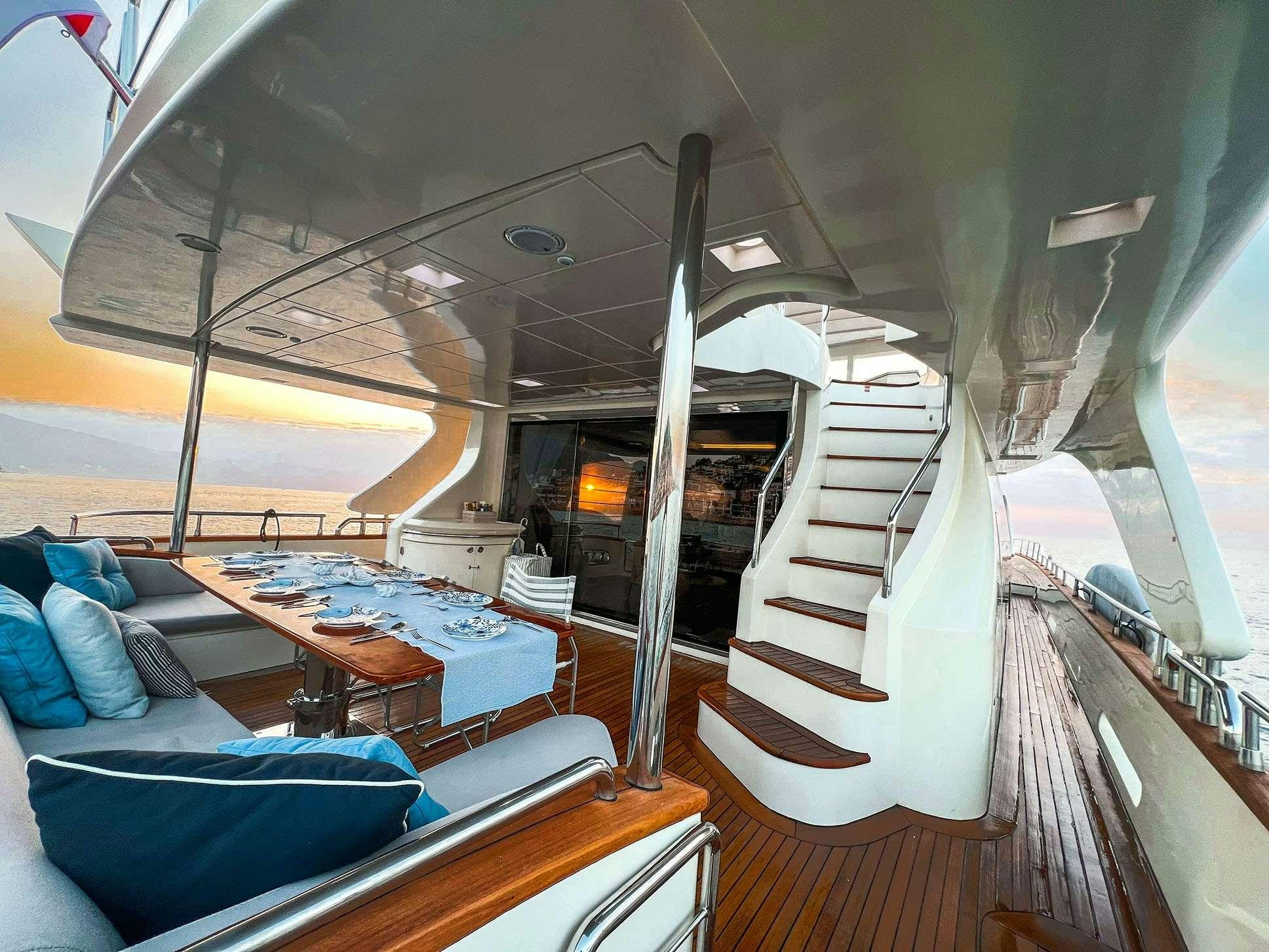 a boat with a staircase and a couch in the background aboard EL GABO Yacht for Charter