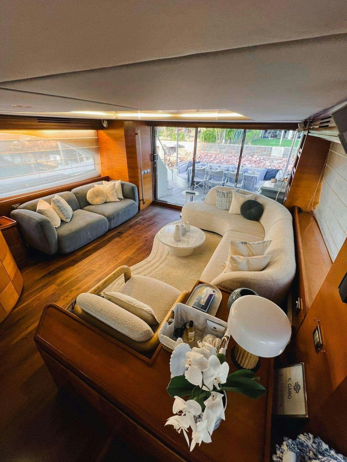 a room with a couch and a table with chairs aboard EL GABO Yacht for Charter