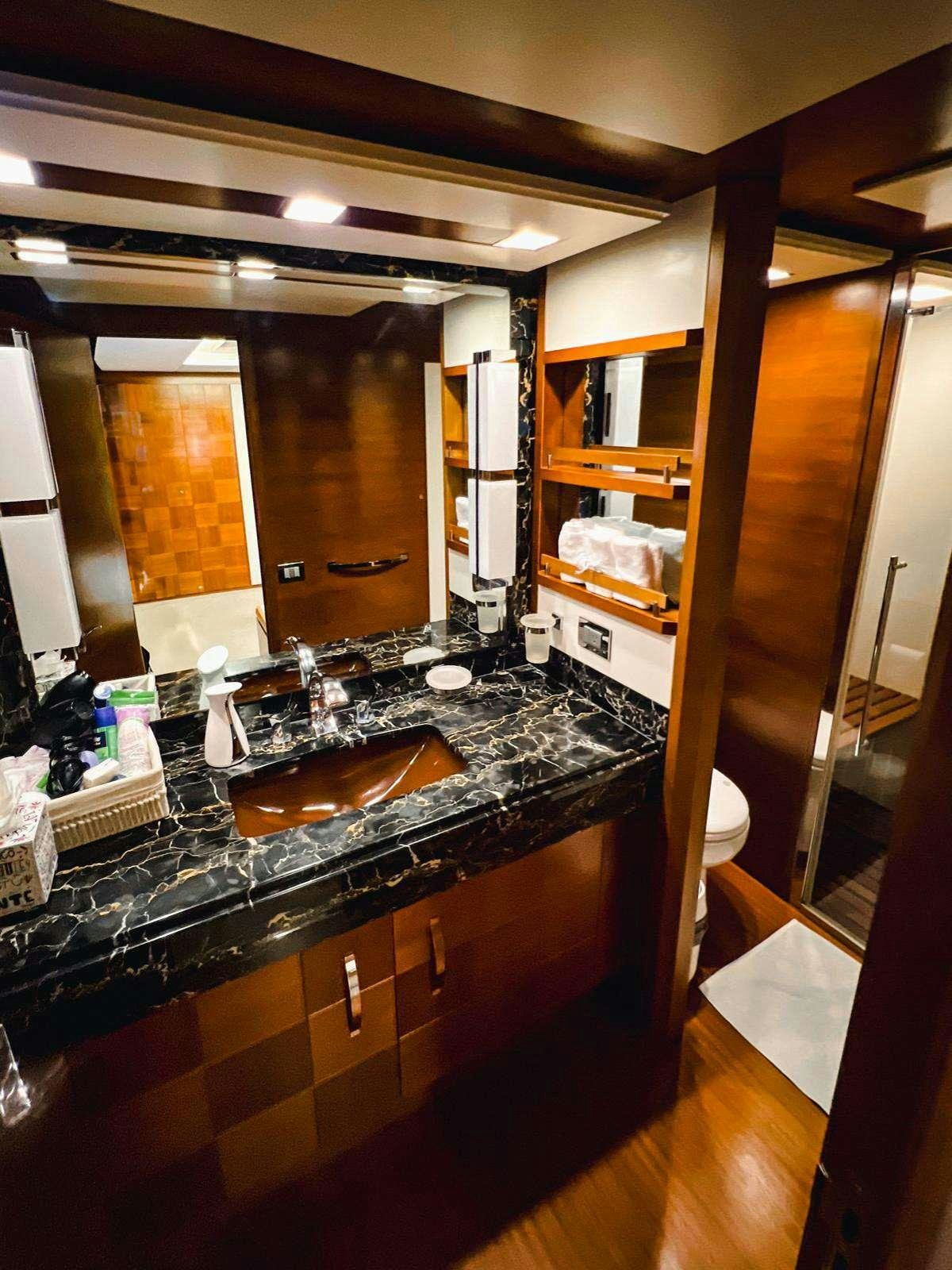 a bathroom with a large mirror aboard EL GABO Yacht for Charter