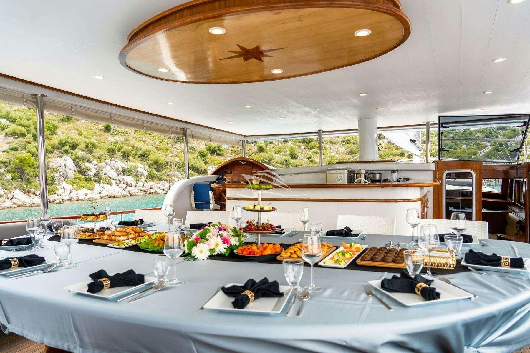 a table set for a dinner aboard QUESTA VITA Yacht for Charter