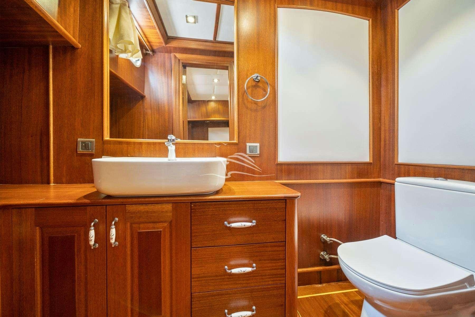 a bathroom with a sink and toilet aboard QUESTA VITA Yacht for Charter