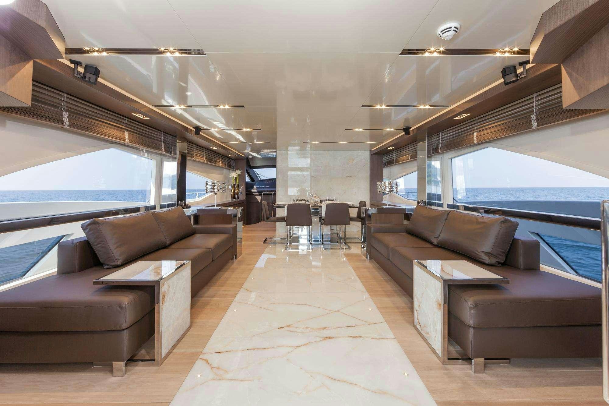 a living room with a couch and a large window aboard WHY NOT Yacht for Charter