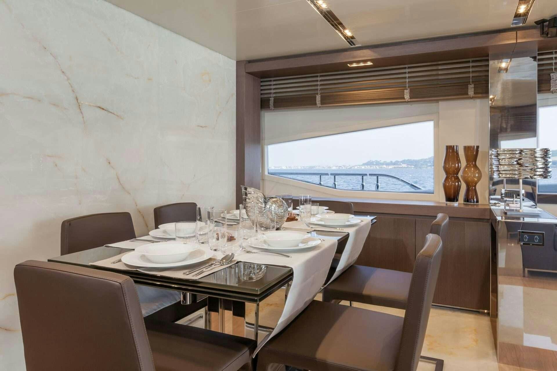 a dining room with a table and chairs aboard WHY NOT Yacht for Charter