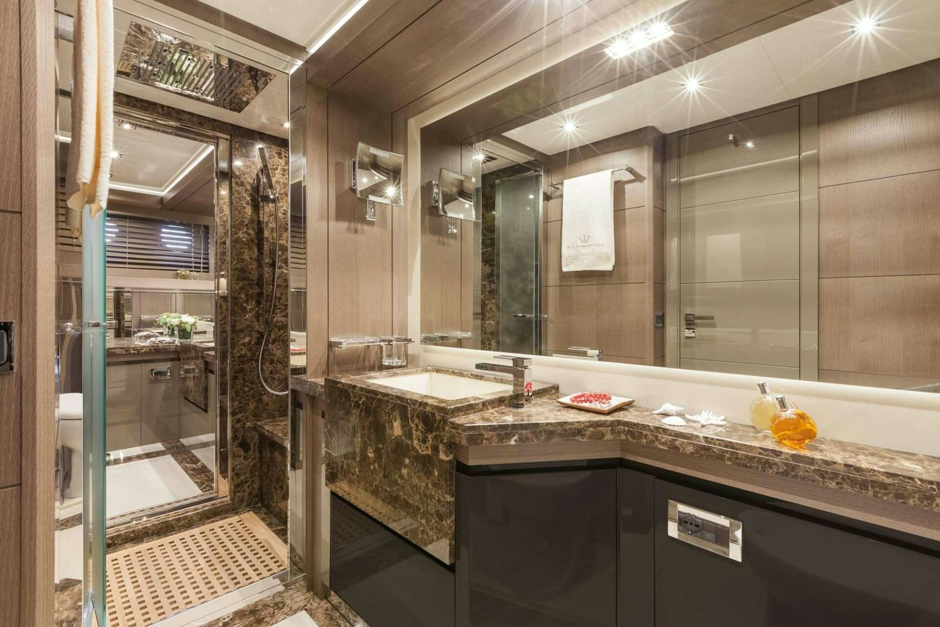 a bathroom with marble counters aboard WHY NOT Yacht for Charter
