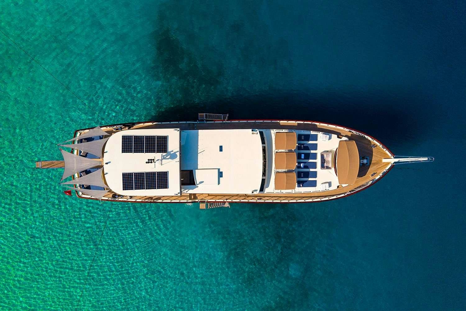 a white house on a body of water aboard ALWAYS SMILE Yacht for Charter