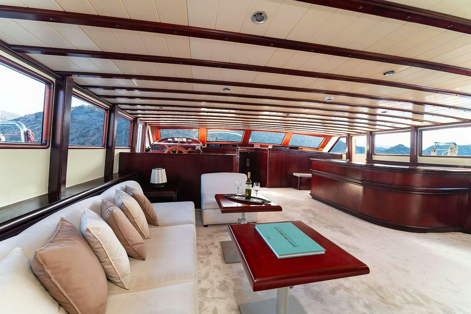a room with a couch and a table aboard ALWAYS SMILE Yacht for Charter
