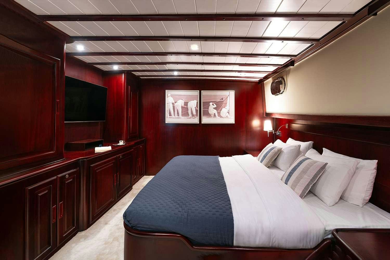a bed in a room aboard ALWAYS SMILE Yacht for Charter