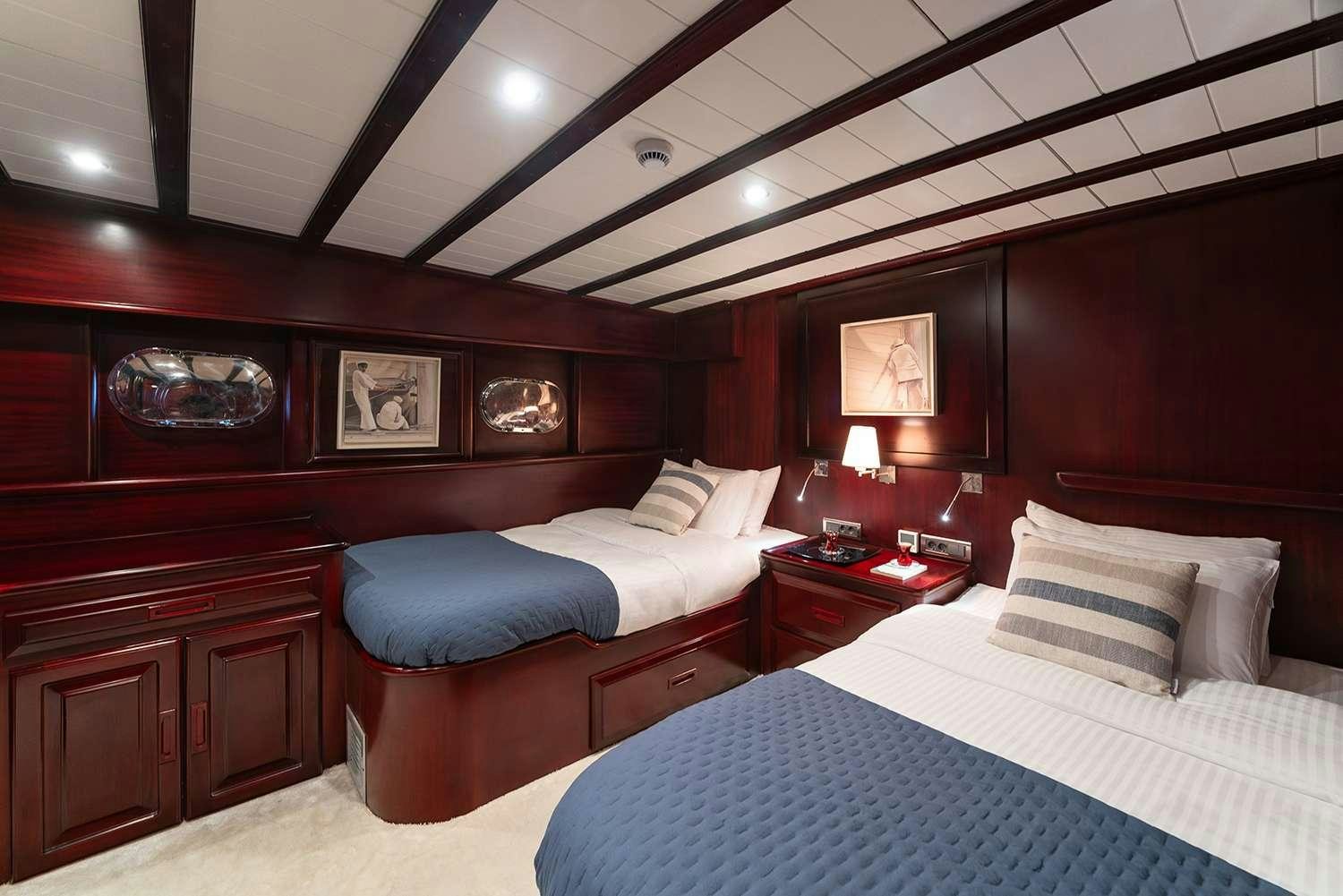 a room with two beds aboard ALWAYS SMILE Yacht for Charter