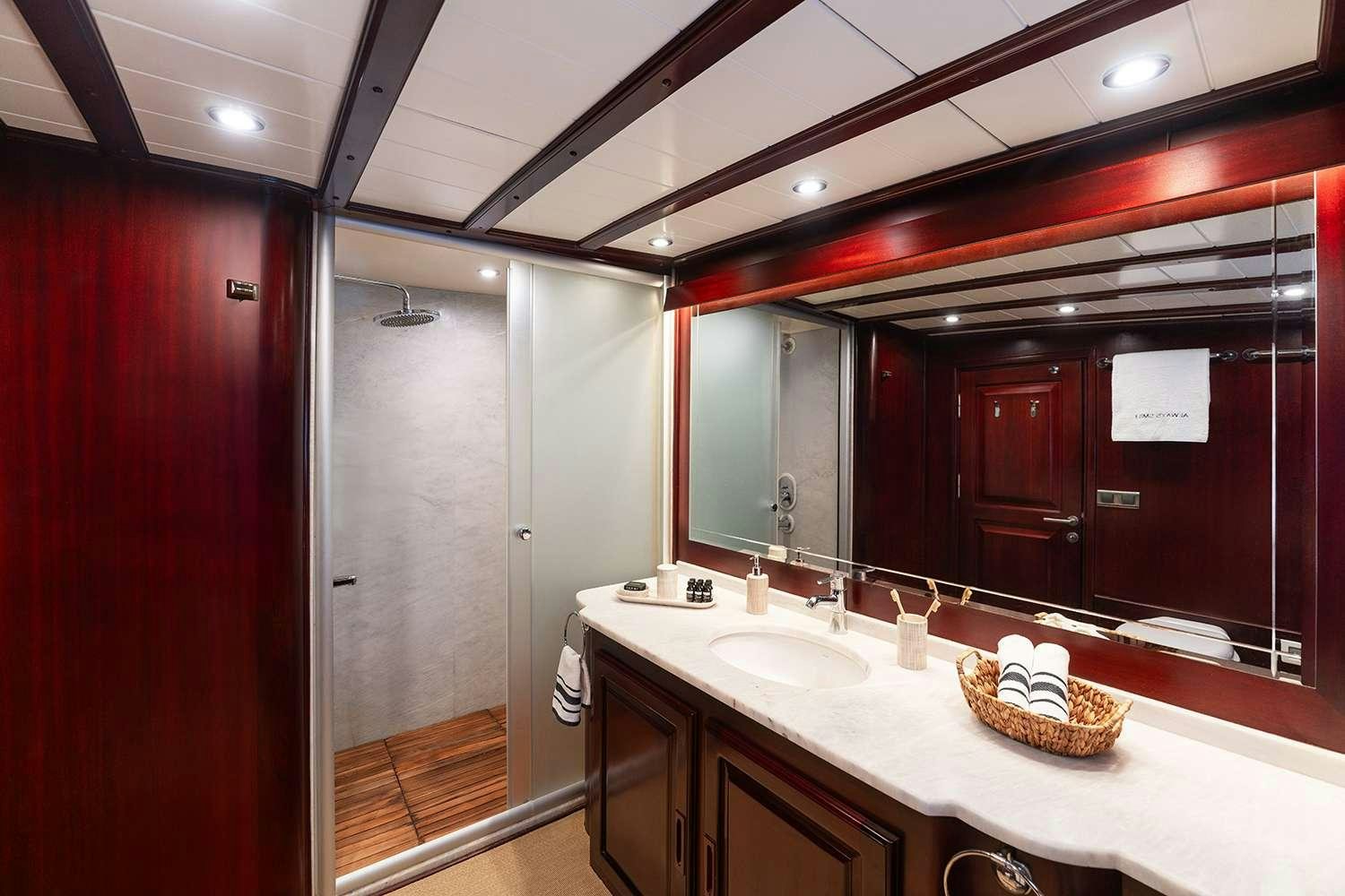a bathroom with a large mirror aboard ALWAYS SMILE Yacht for Charter