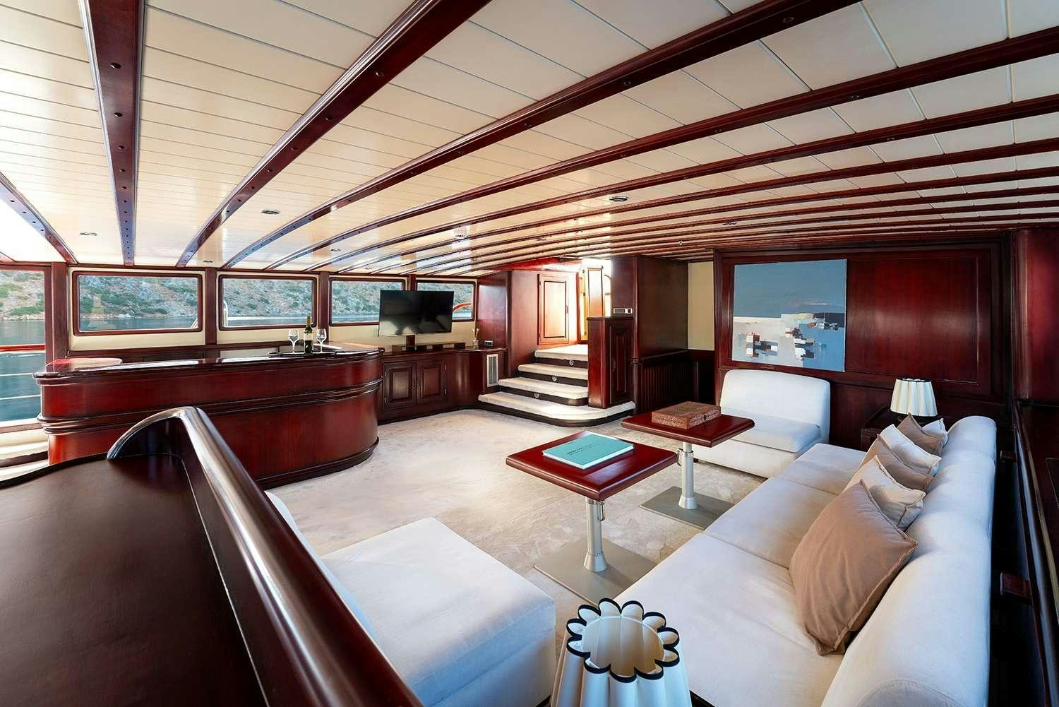 a living room with a large wood ceiling aboard ALWAYS SMILE Yacht for Charter