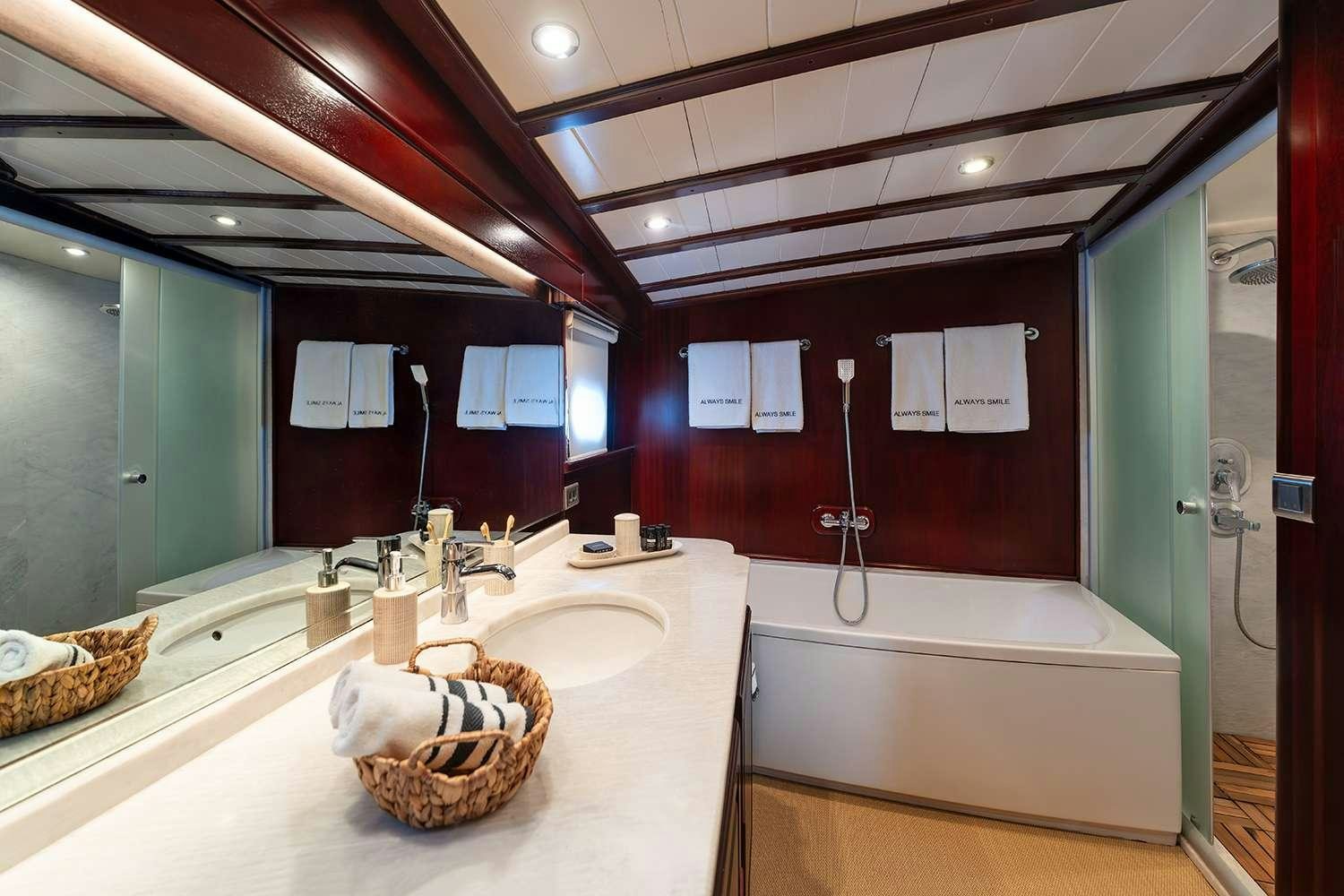 a bathroom with a large mirror aboard ALWAYS SMILE Yacht for Charter