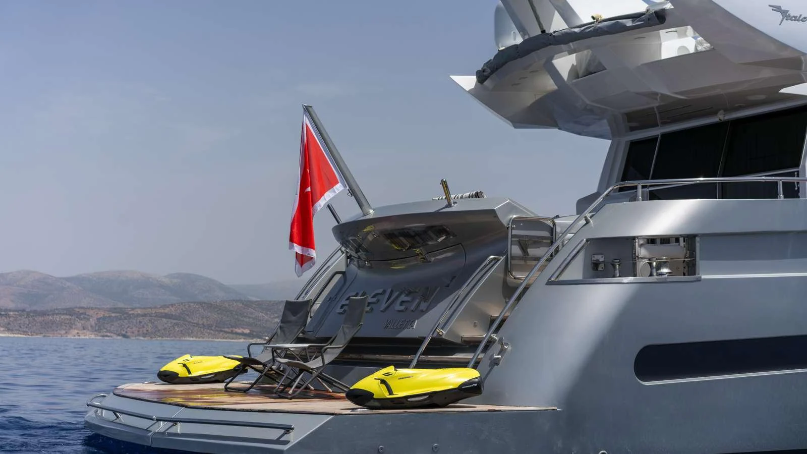 a boat with a flag on the front aboard ELEVEN I Yacht for Charter