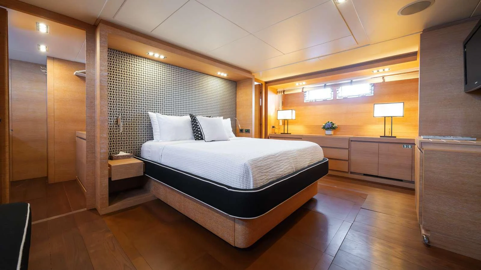 a room with a bed and a tv aboard ELEVEN I Yacht for Charter