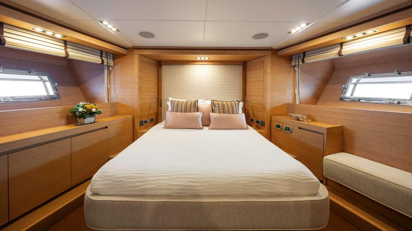 a room with a bed and a desk aboard ELEVEN I Yacht for Charter