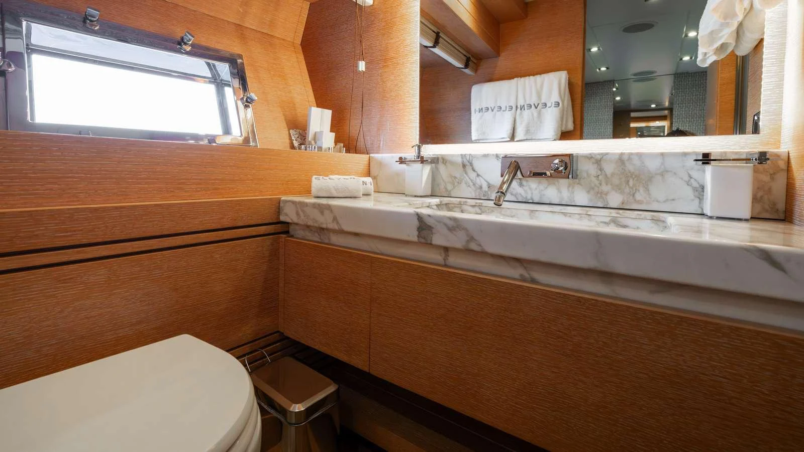 a bathroom with a tub sink and toilet aboard ELEVEN I Yacht for Charter