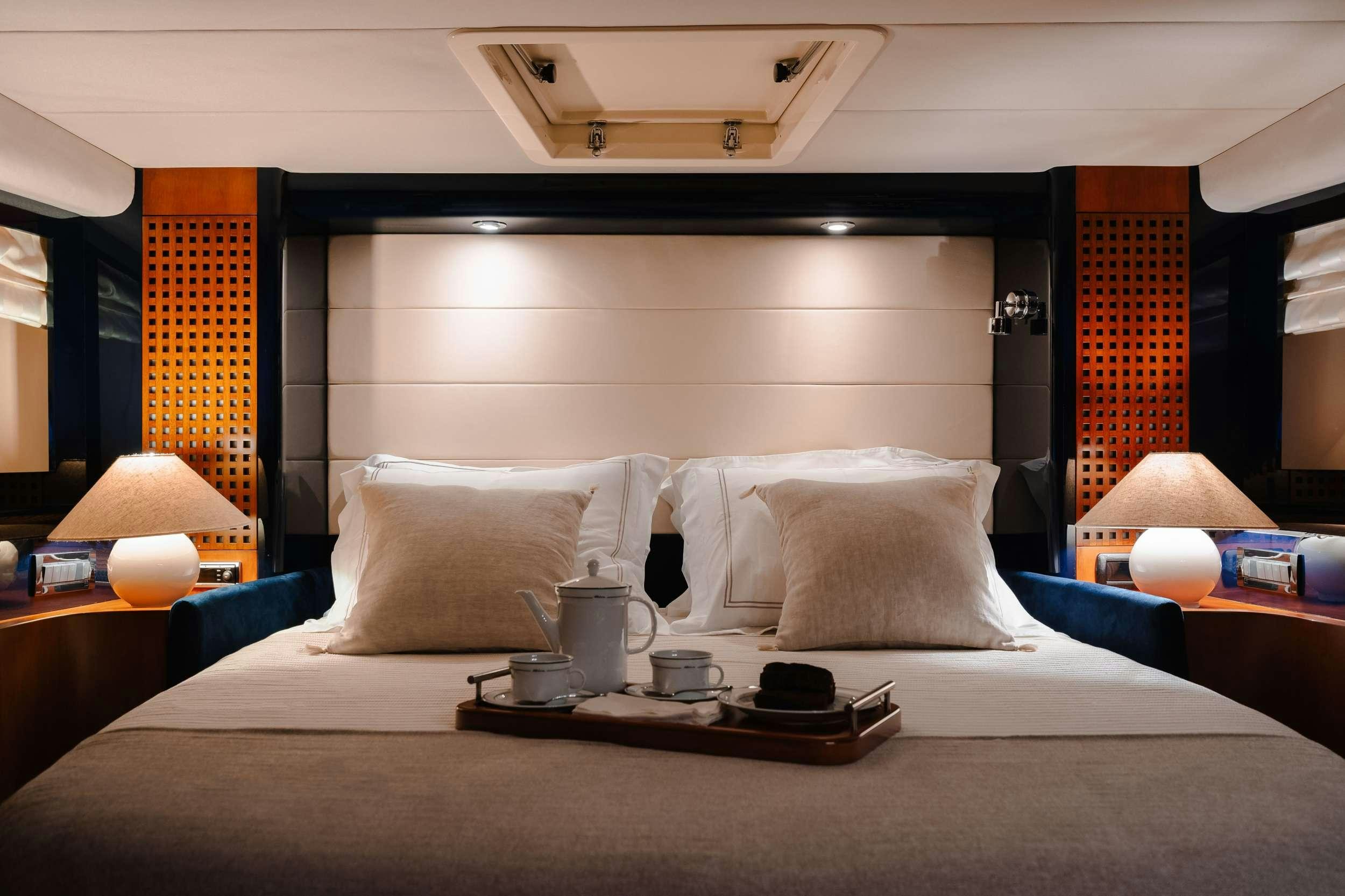 a bed with pillows and a tray aboard ETERNO Yacht for Charter