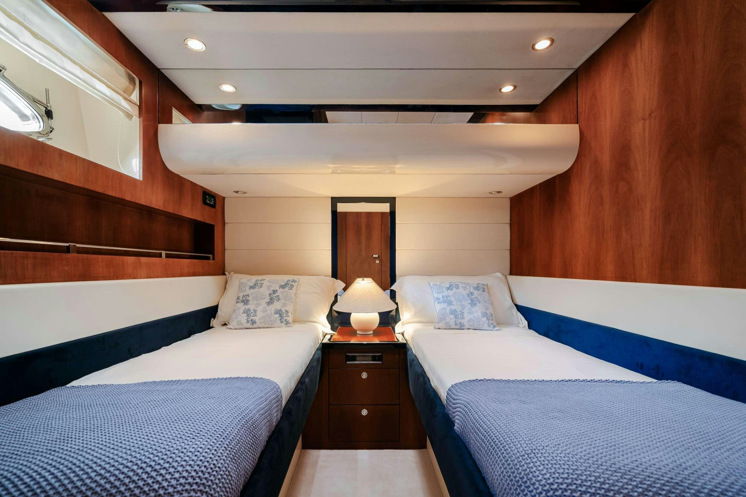 a room with beds and a wood wall aboard ETERNO Yacht for Charter