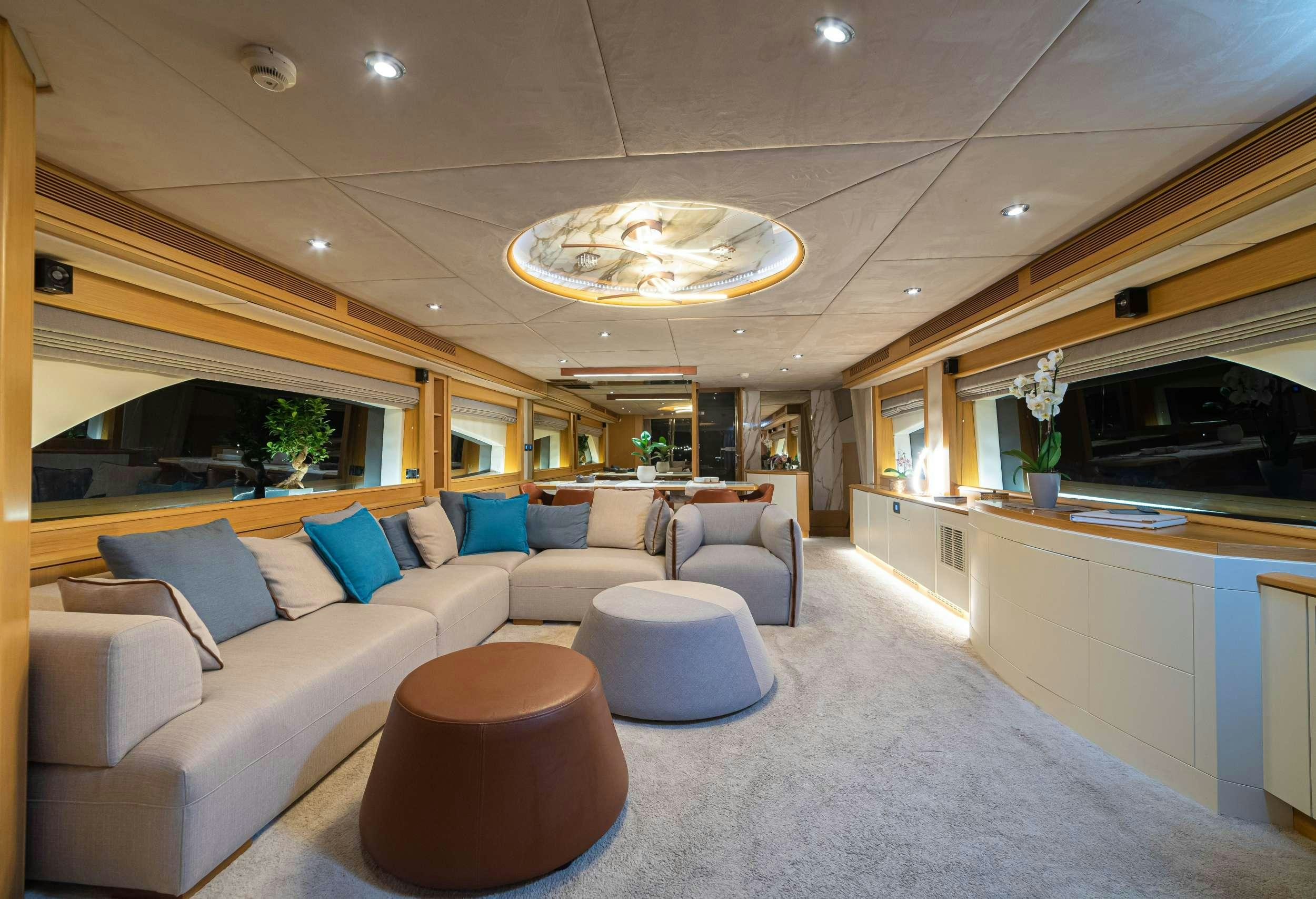 a living room with a couch and a table aboard STELA 117 Yacht for Charter