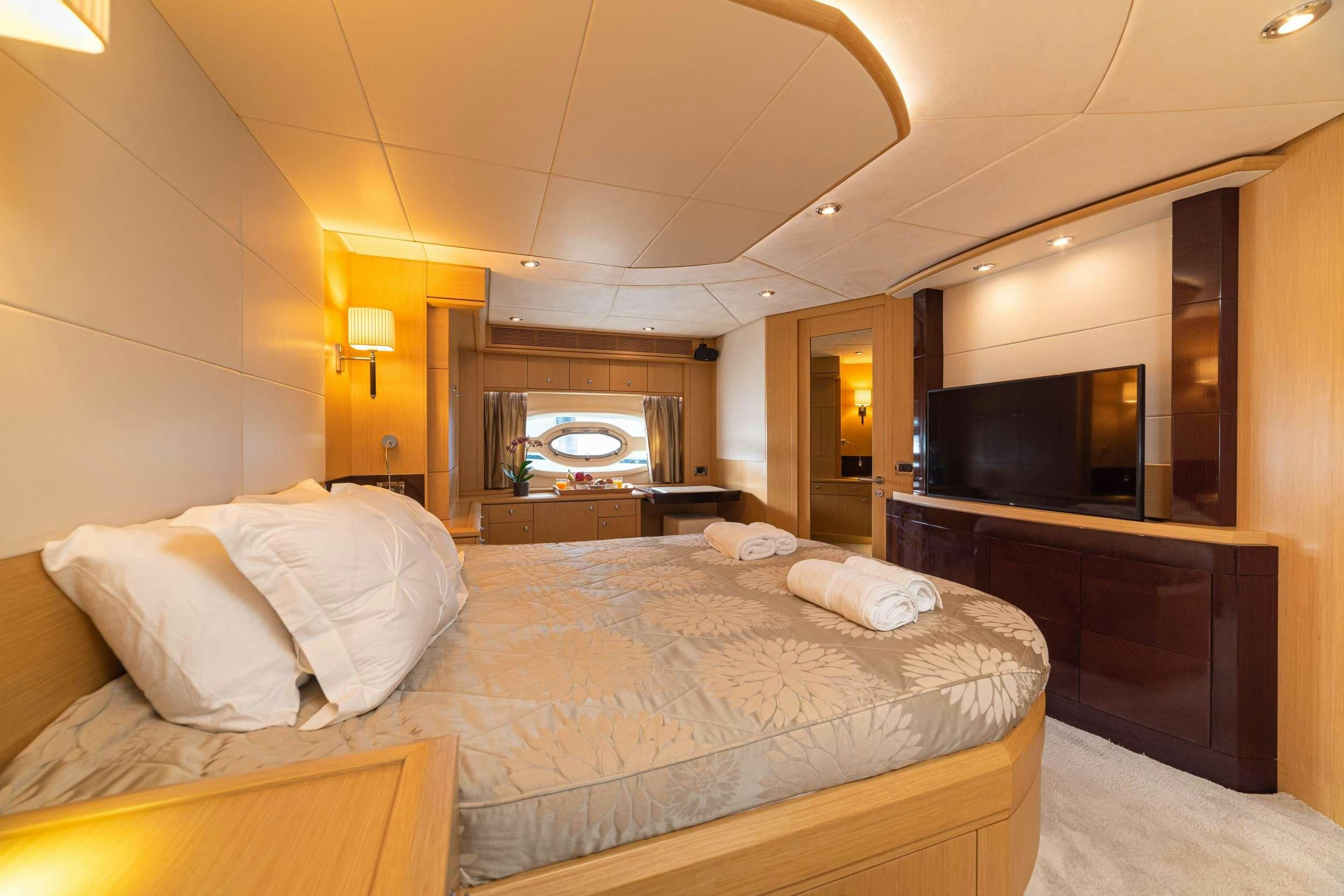 a bedroom with a bed and a fireplace aboard STELA 117 Yacht for Charter