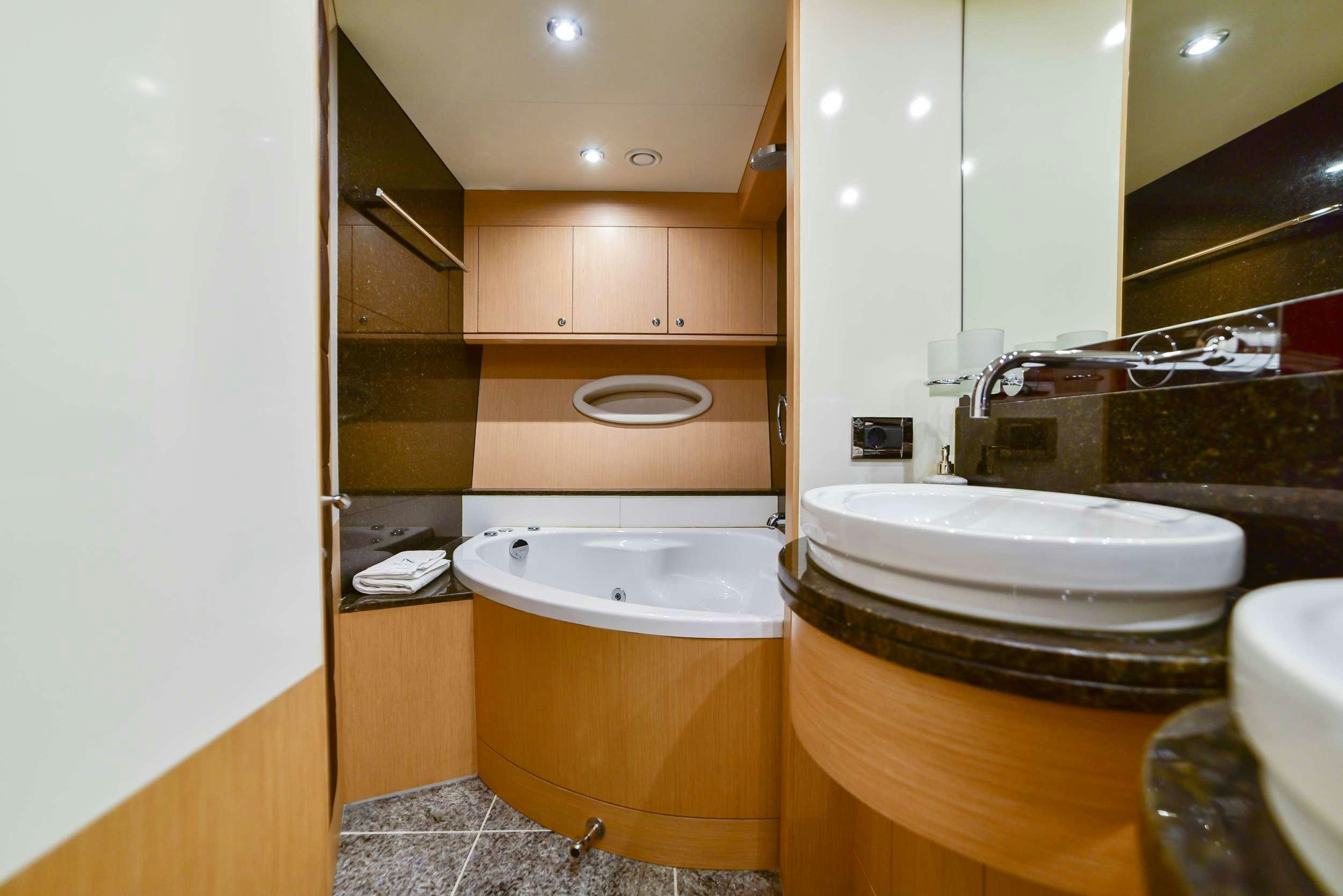 a bathroom with a tub sink and toilet aboard STELA 117 Yacht for Charter