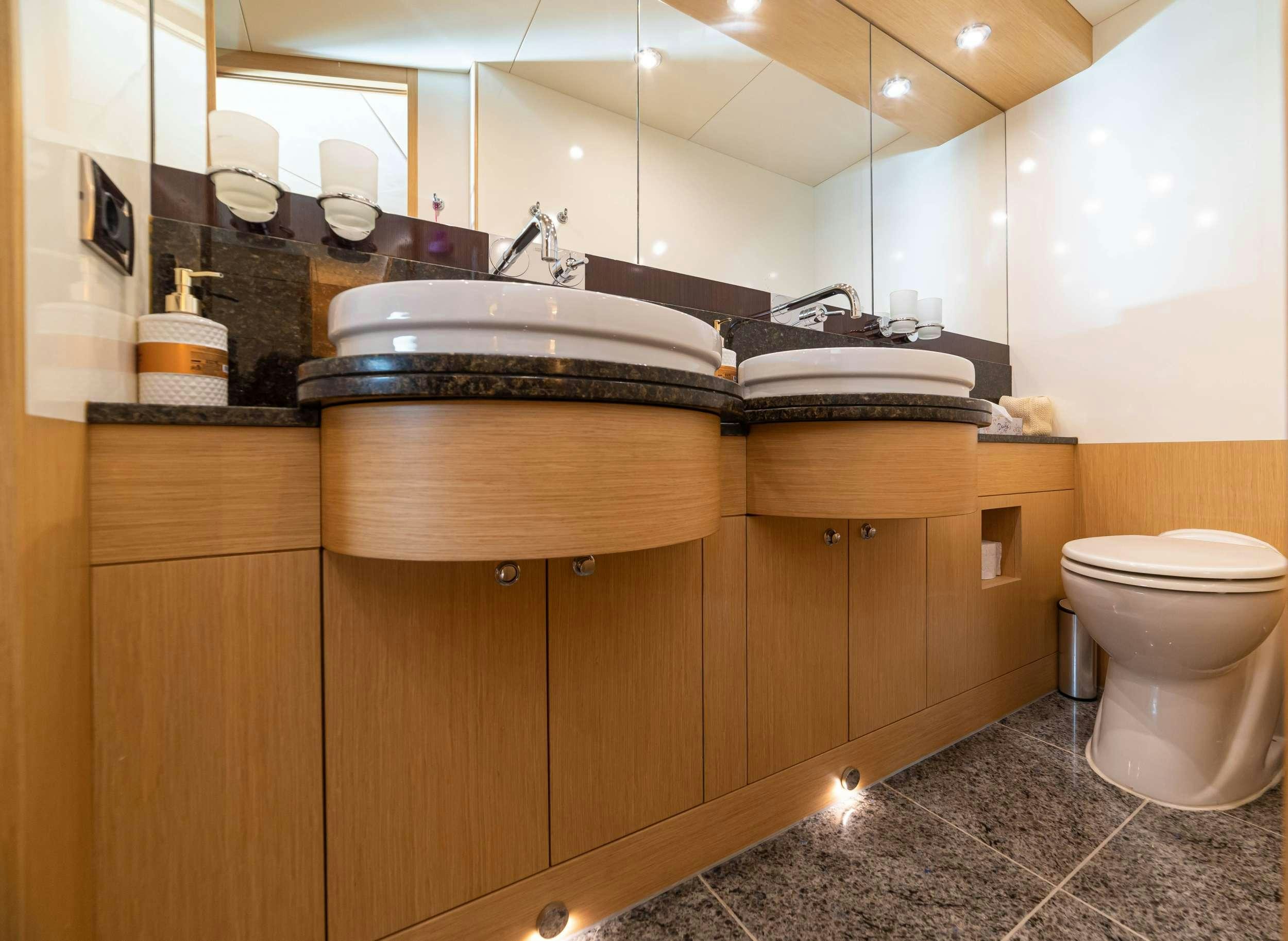 a bathroom with a sink and toilet aboard STELA 117 Yacht for Charter