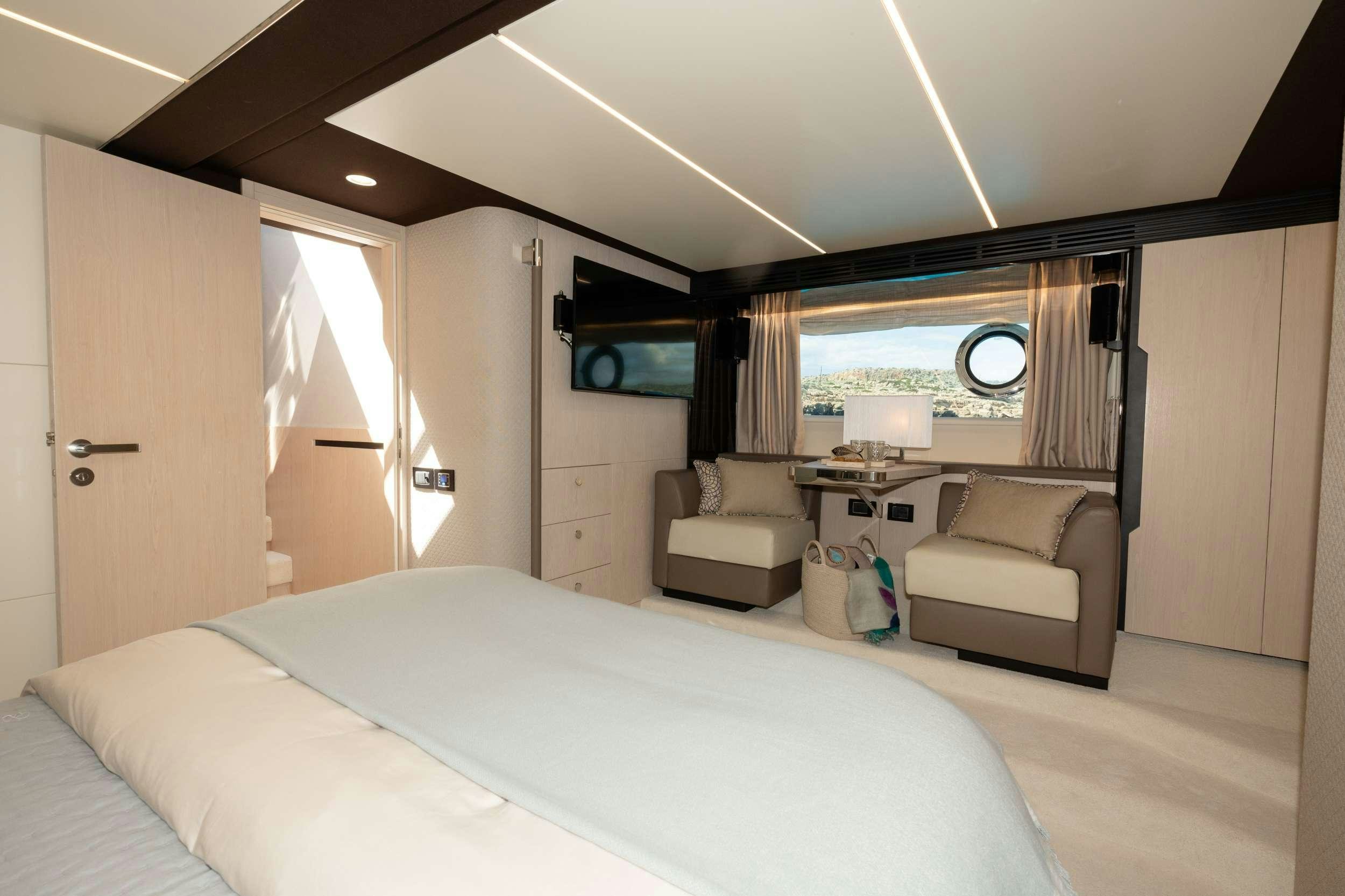a bedroom with a bed and a desk aboard SEA YA Yacht for Charter