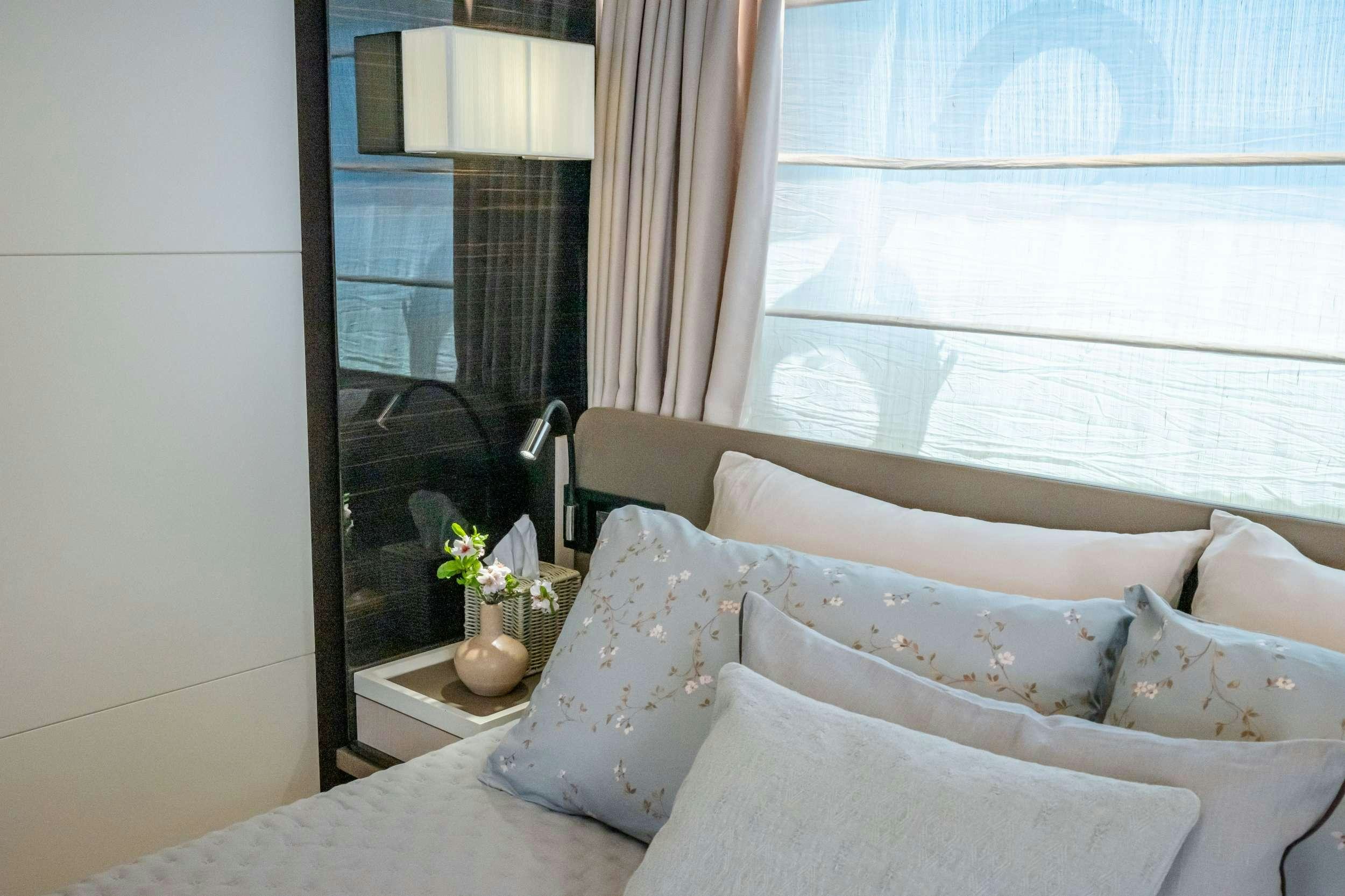 a bed with white pillows aboard SEA YA Yacht for Charter