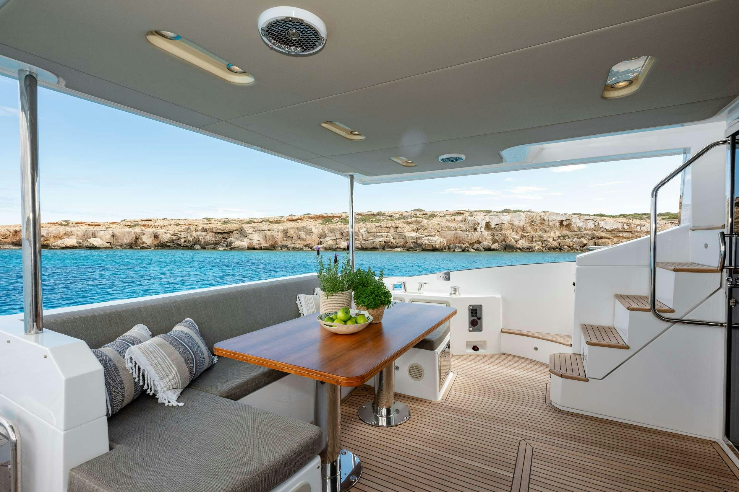a room with a table and a view of the ocean aboard SEA YA Yacht for Charter