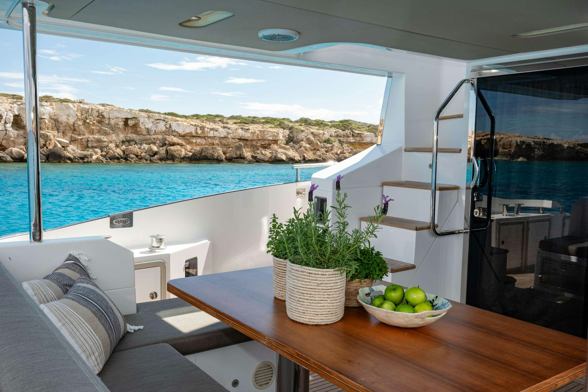 a room with a table and a plant on the table aboard SEA YA Yacht for Charter