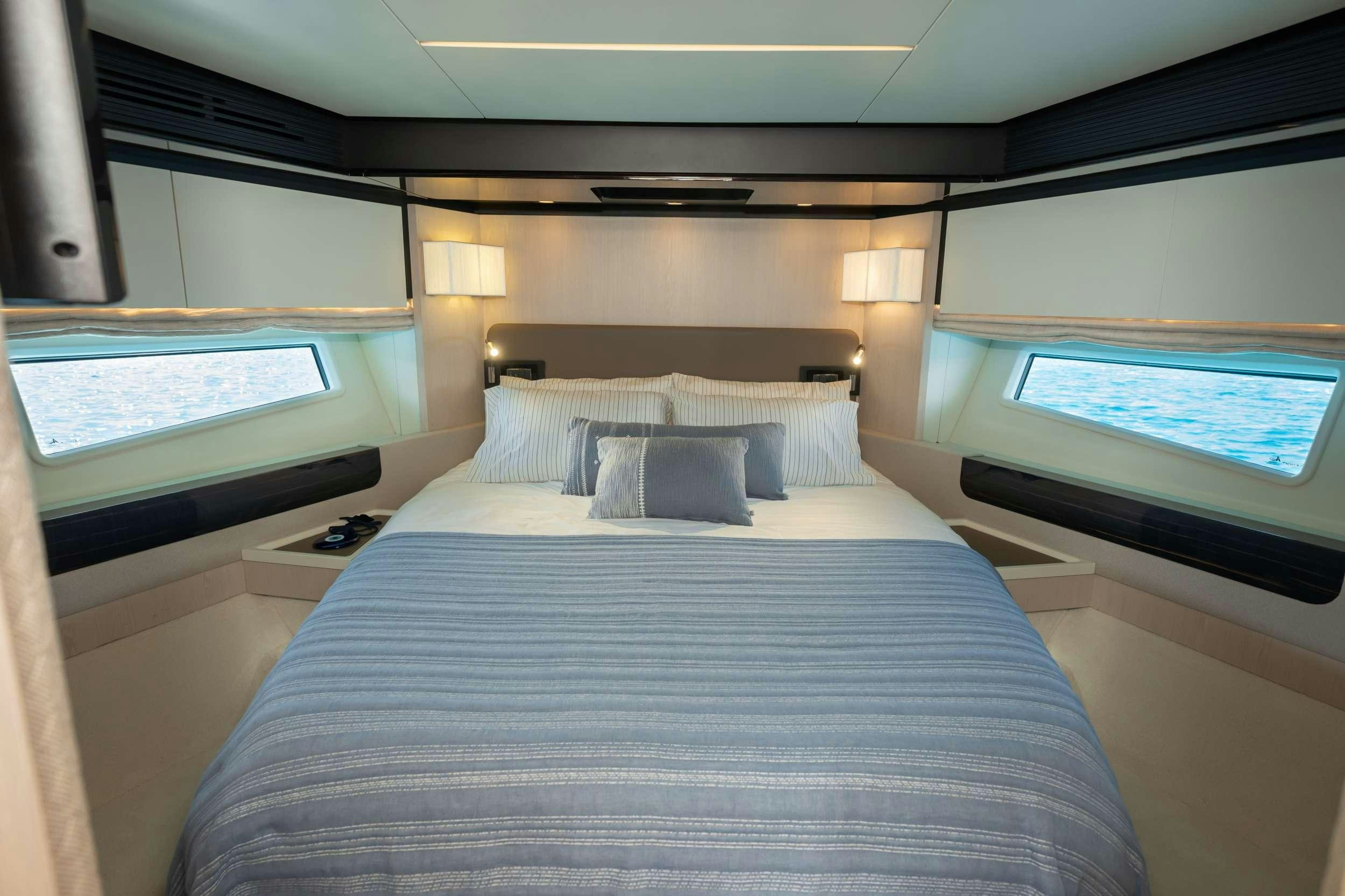 a bed with a television and a bed in a room aboard SEA YA Yacht for Charter