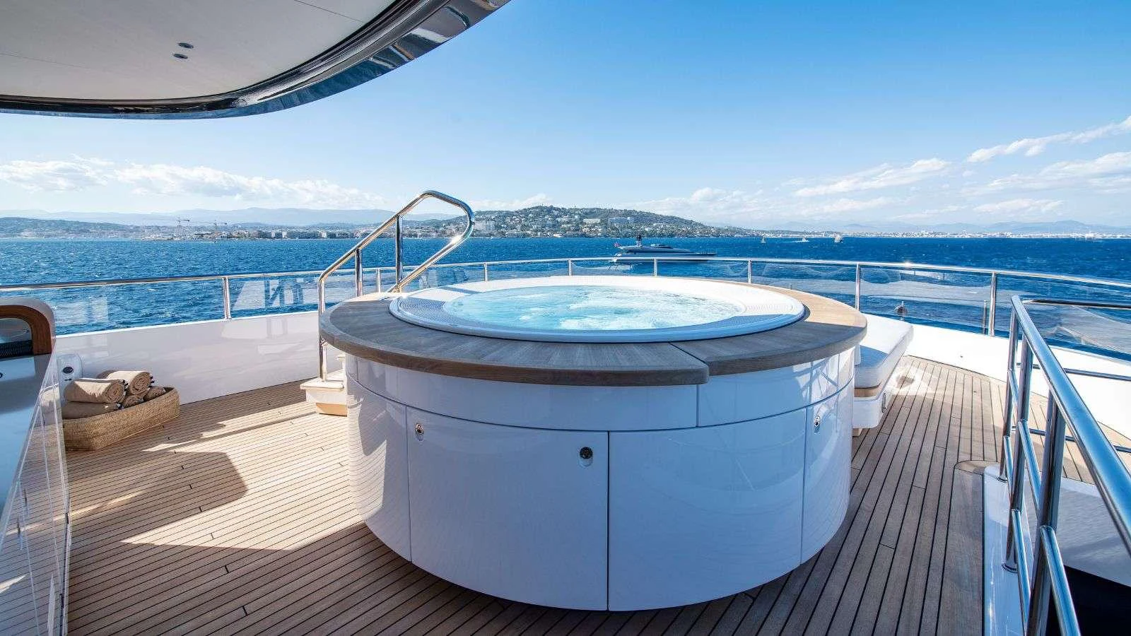 a large pool on a deck overlooking a city aboard NORTHERN ESCAPE Yacht for Charter