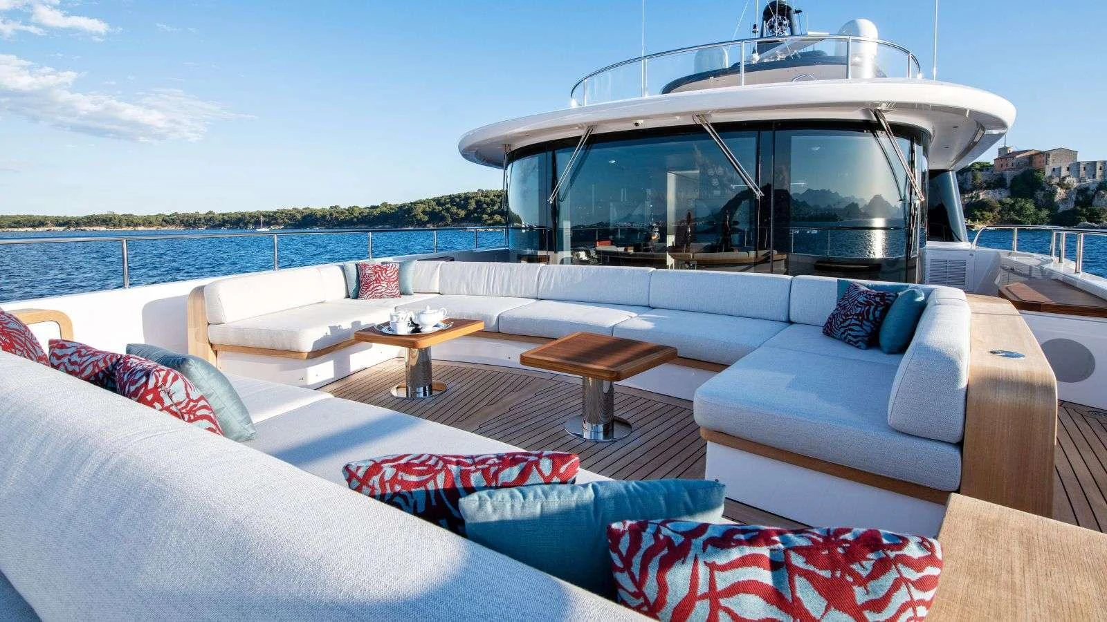 a living room with a large white sofa and a large white boat aboard NORTHERN ESCAPE Yacht for Charter