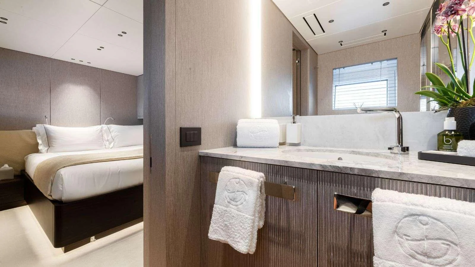 a bedroom with a bed and a sink aboard NORTHERN ESCAPE Yacht for Charter