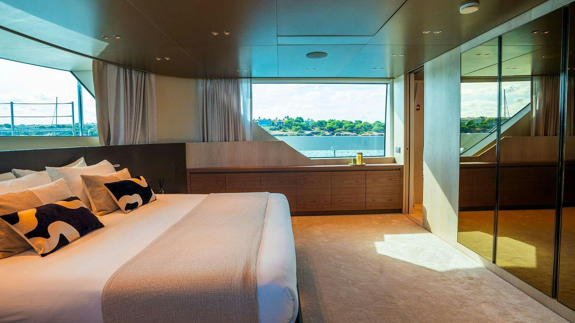 a room with a bed and a window aboard ON TIME Yacht for Charter