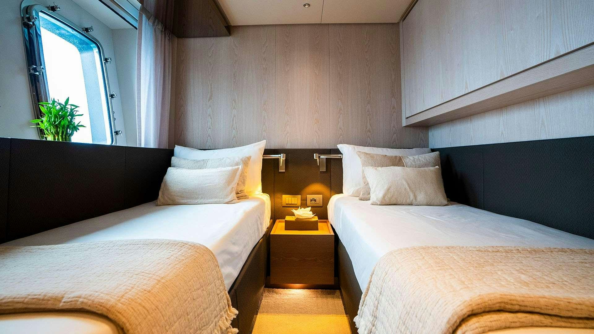 a room with two beds aboard ON TIME Yacht for Charter