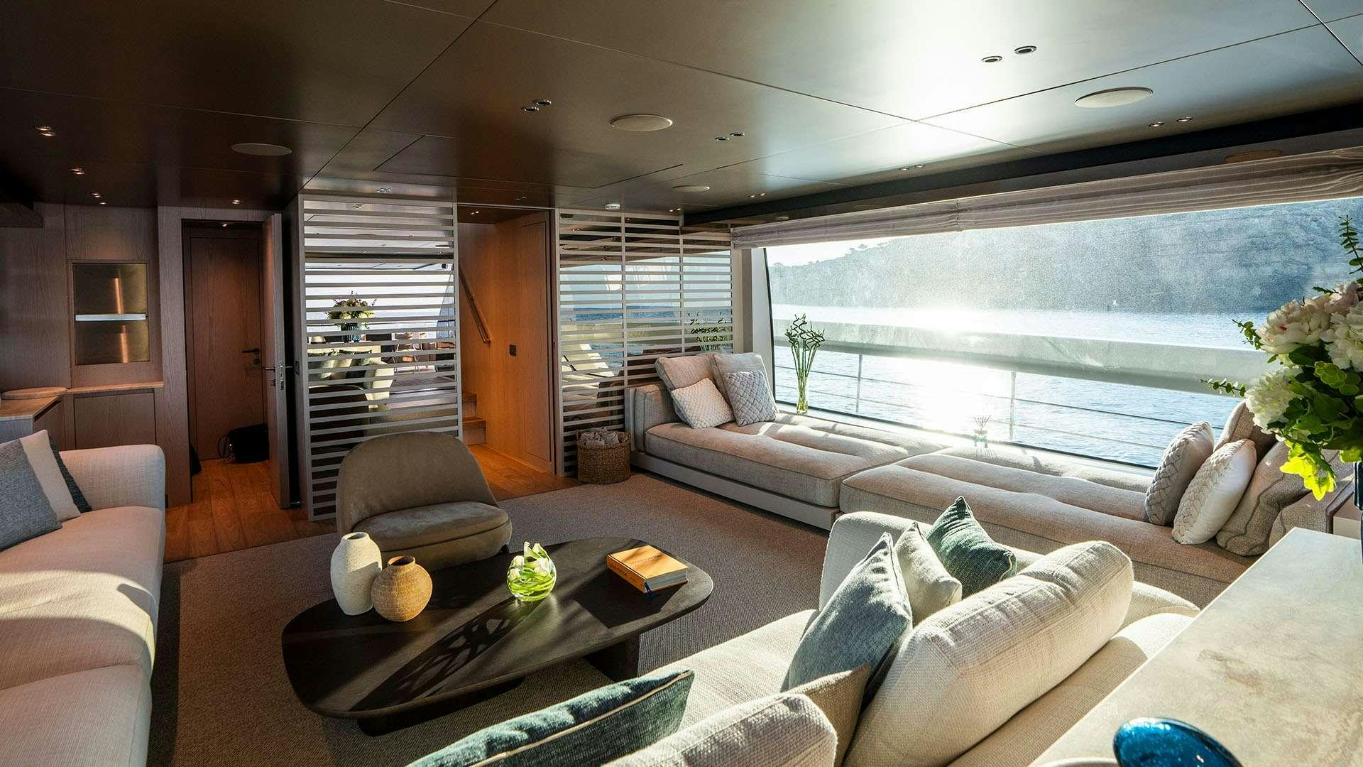 a living room with a large window aboard ON TIME Yacht for Charter