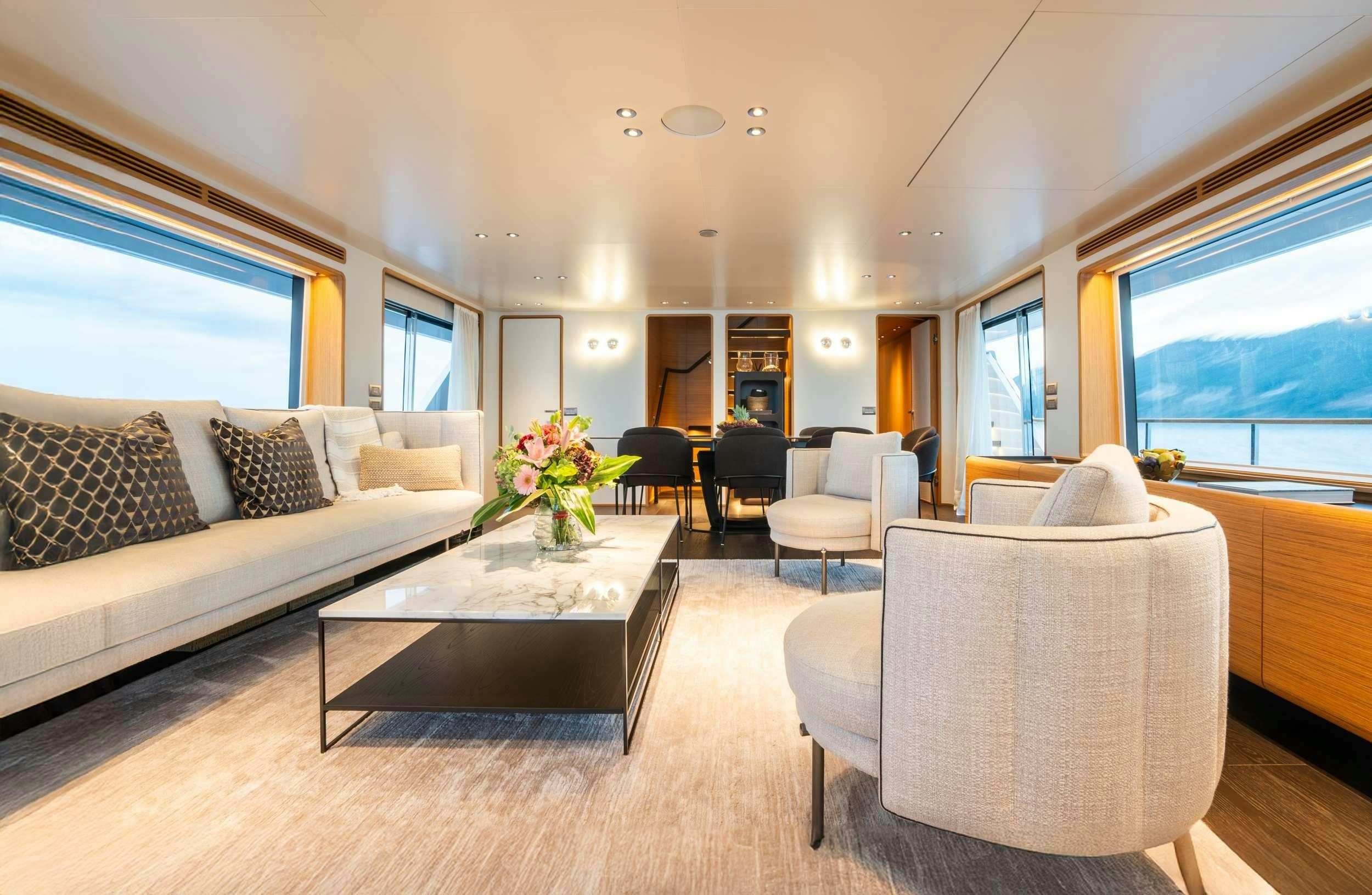 a living room with a couch and a coffee table aboard RARE GEM Yacht for Charter
