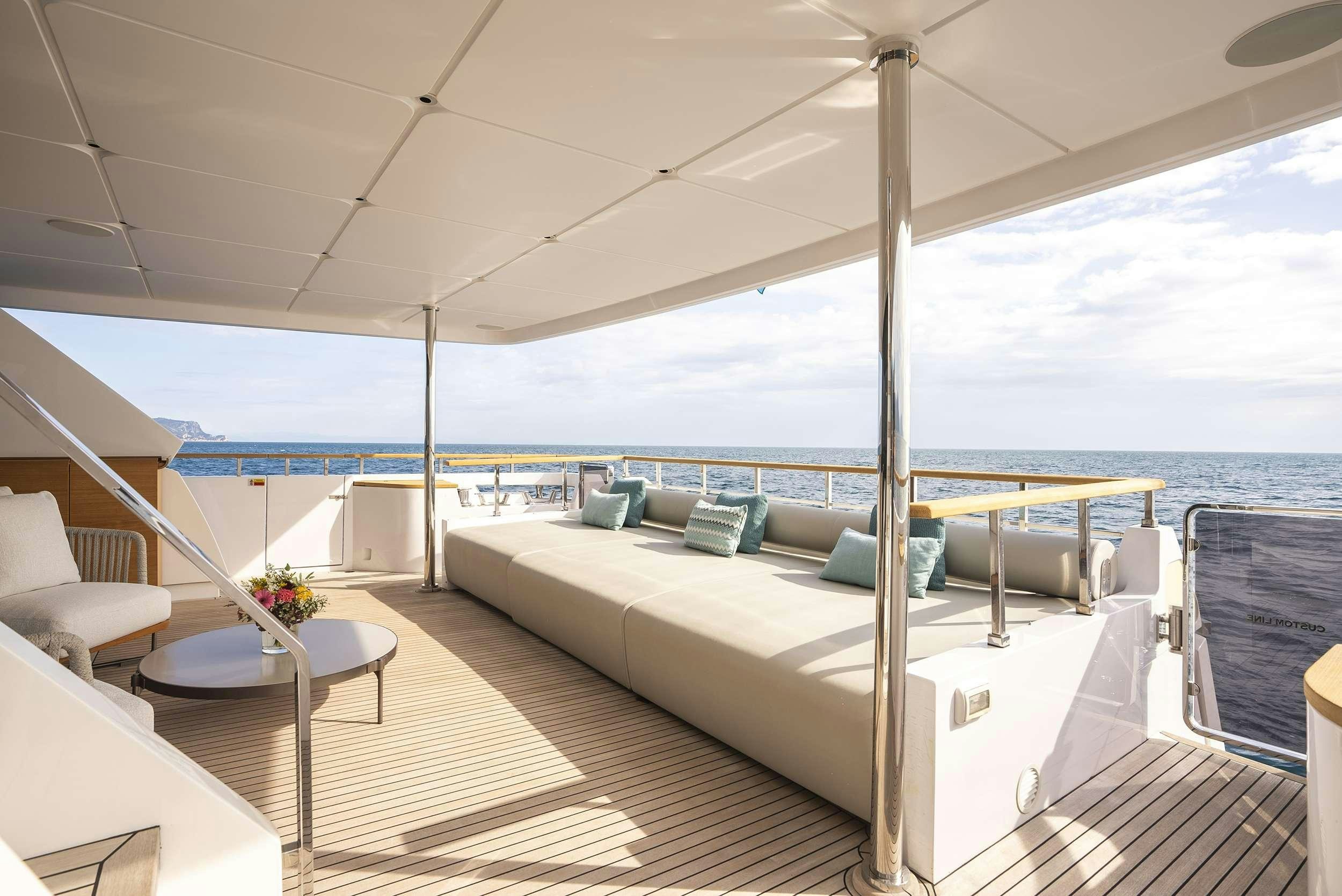 a large white bed on a deck aboard RARE GEM Yacht for Charter
