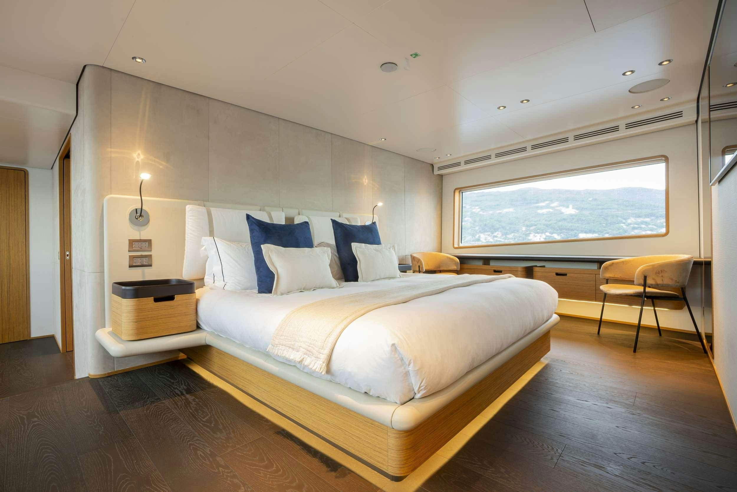 a room with a bed and a window aboard RARE GEM Yacht for Charter
