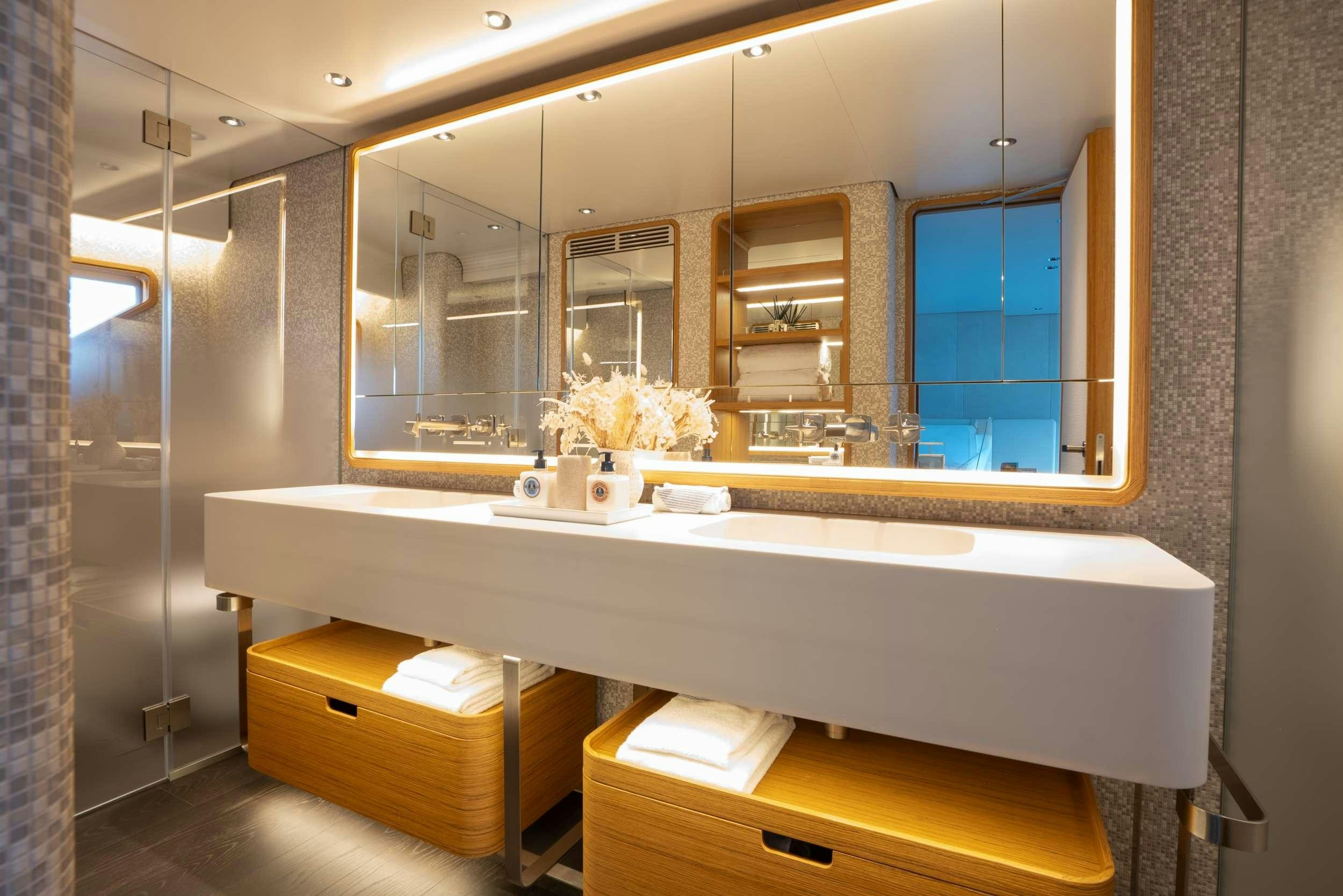 a bathroom with a large mirror aboard RARE GEM Yacht for Charter
