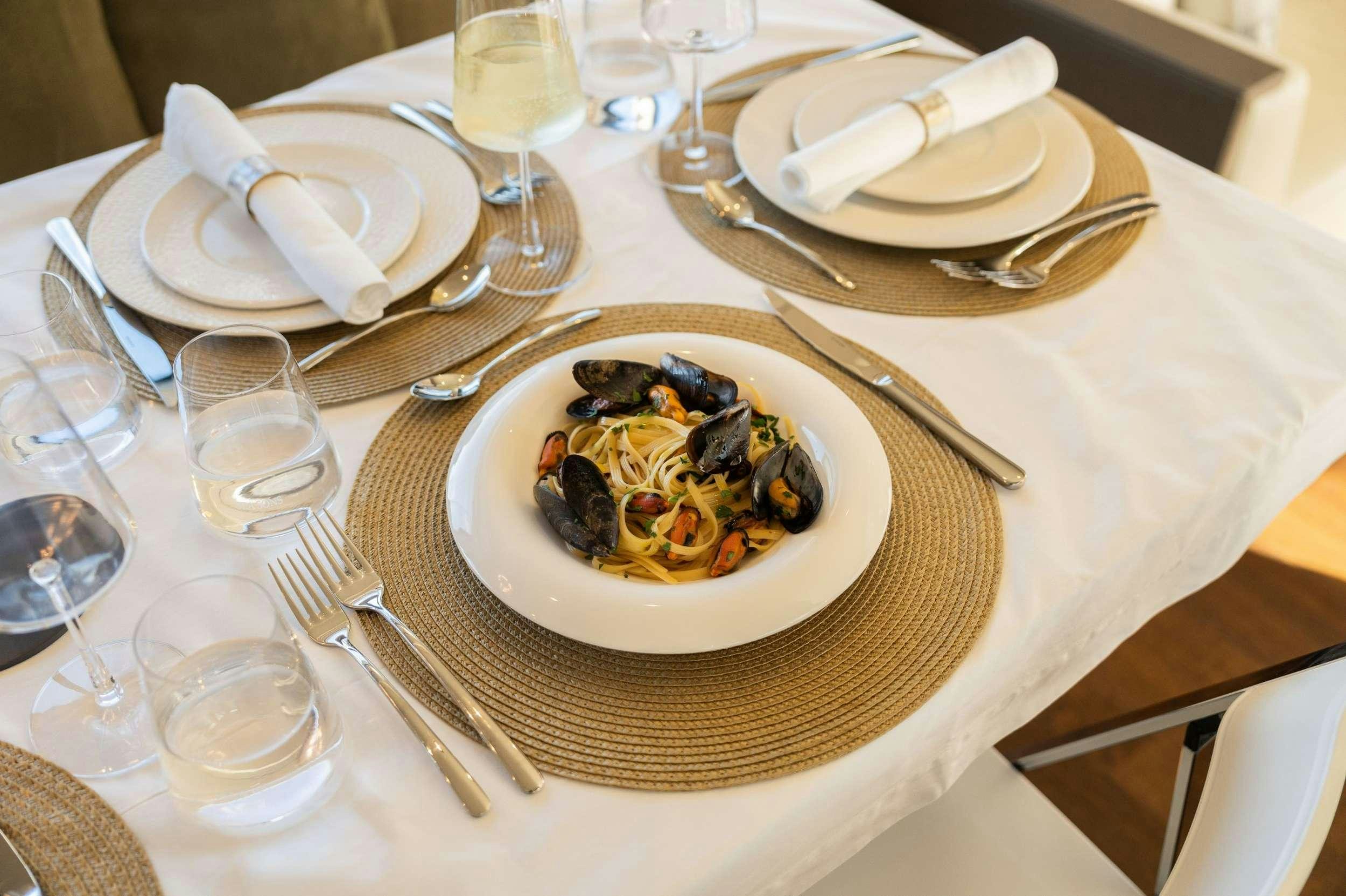 a table with plates and silverware aboard SEA SONS Yacht for Charter