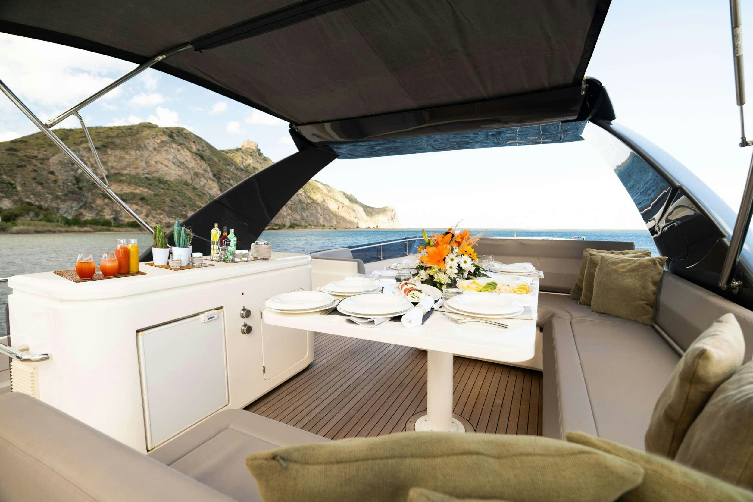 a table with plates and flowers on it aboard SEA SONS Yacht for Charter